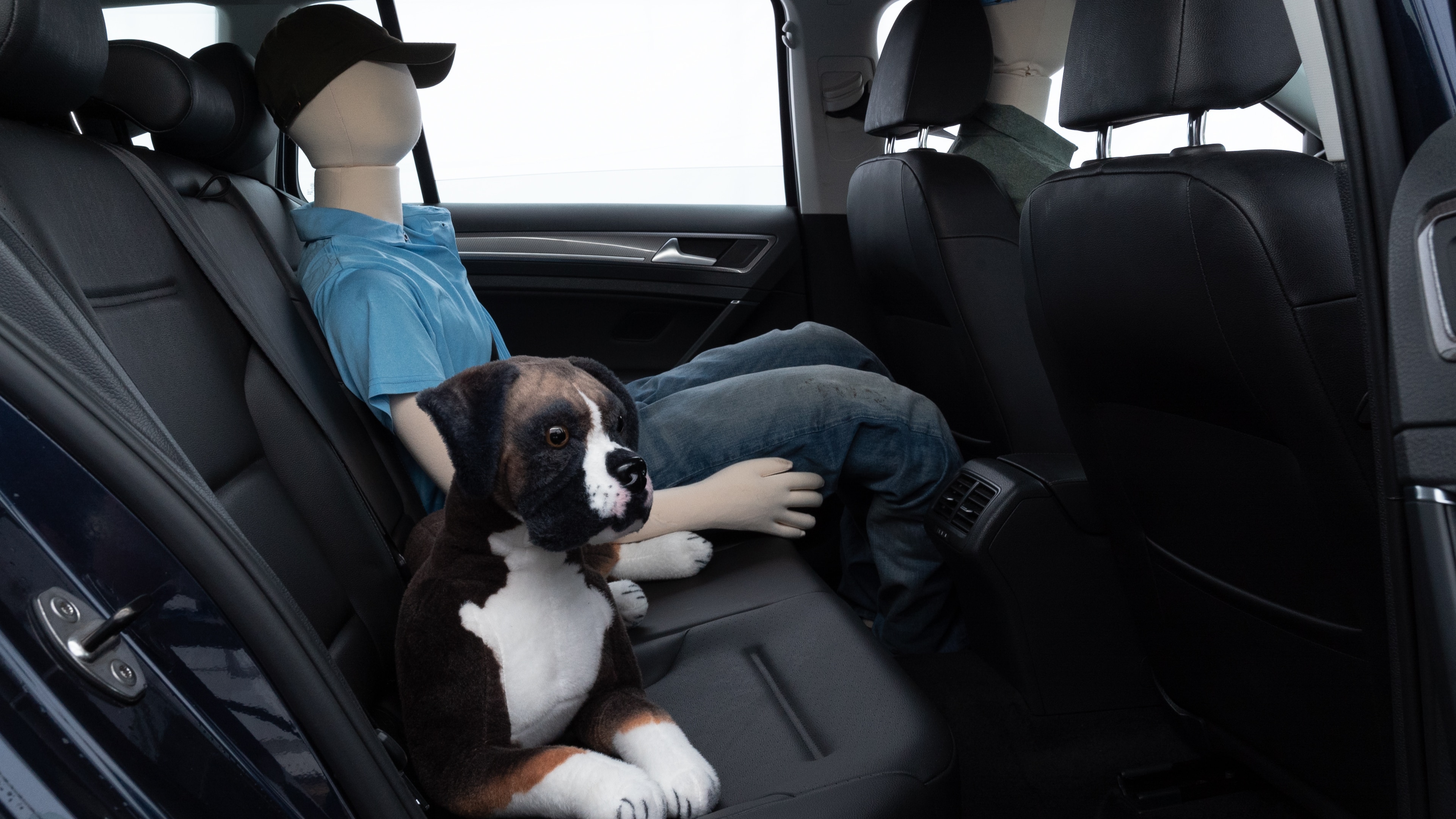 A series of second-row backseat photos is shown including one seating a baby seat and one seating a 6'1" mannequin.