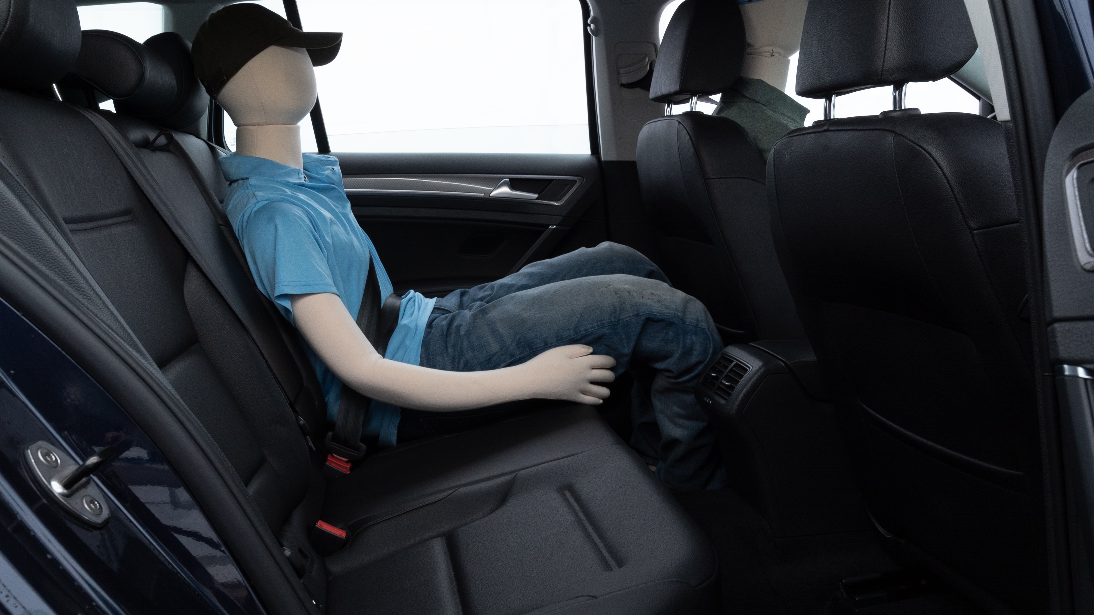 A series of second-row backseat photos is shown including one seating a baby seat and one seating a 6'1" mannequin.
