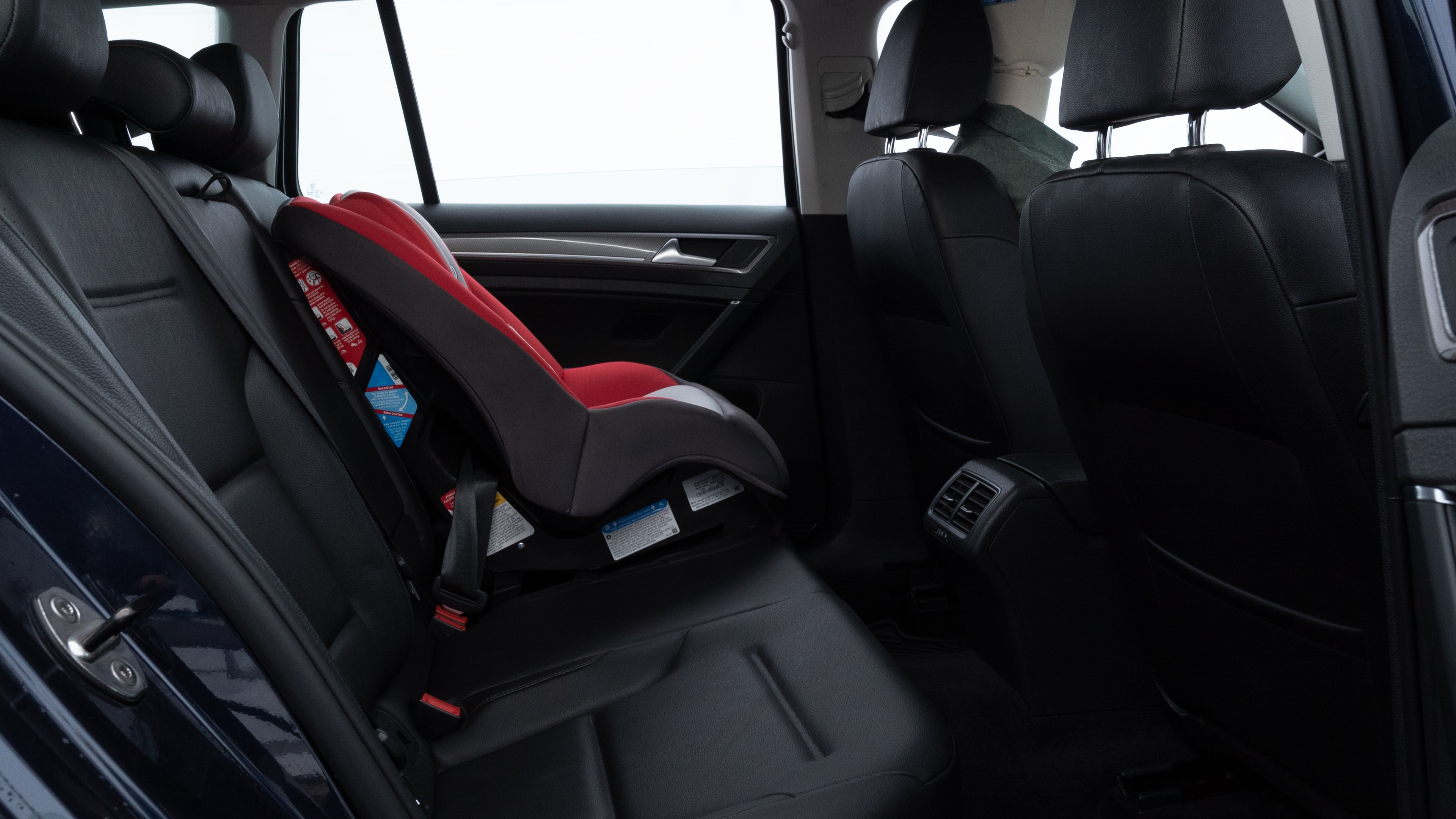 A series of second-row backseat photos is shown including one seating a baby seat and one seating a 6'1" mannequin.