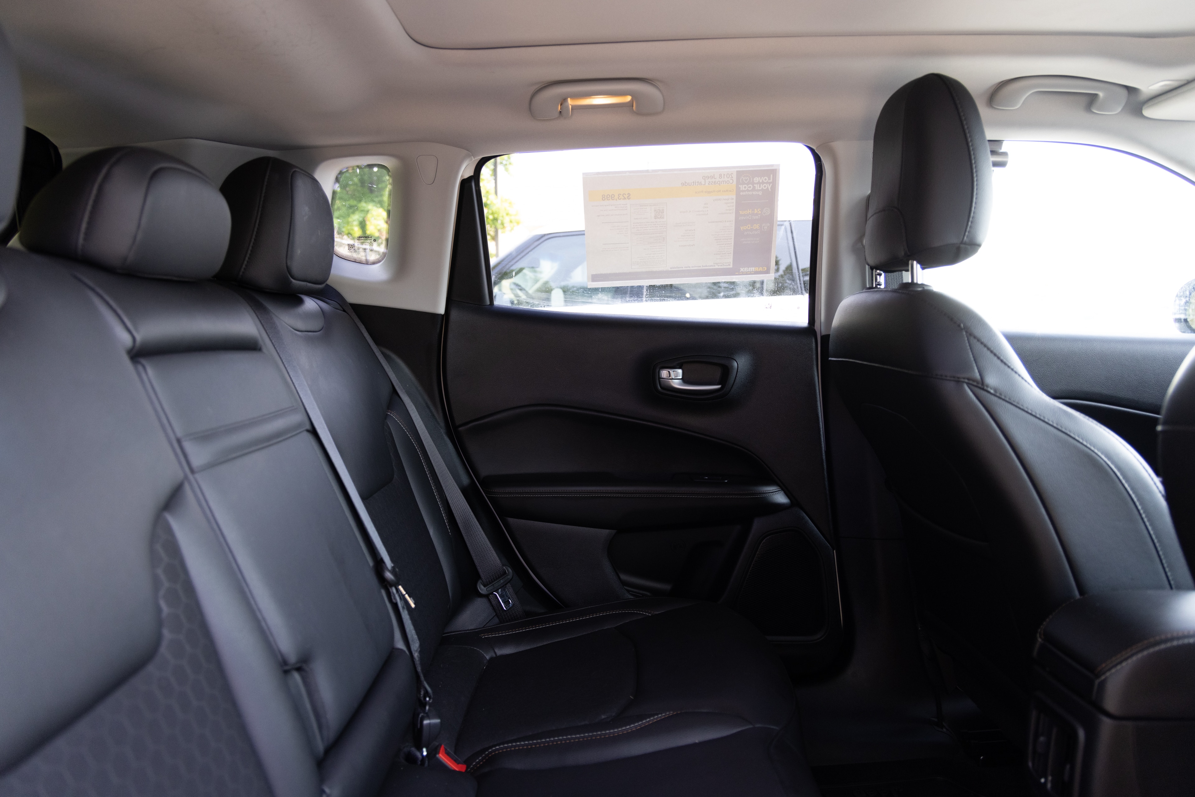 A series of second-row backseat photos is shown including one seating a baby seat and one seating a 6'1" mannequin.