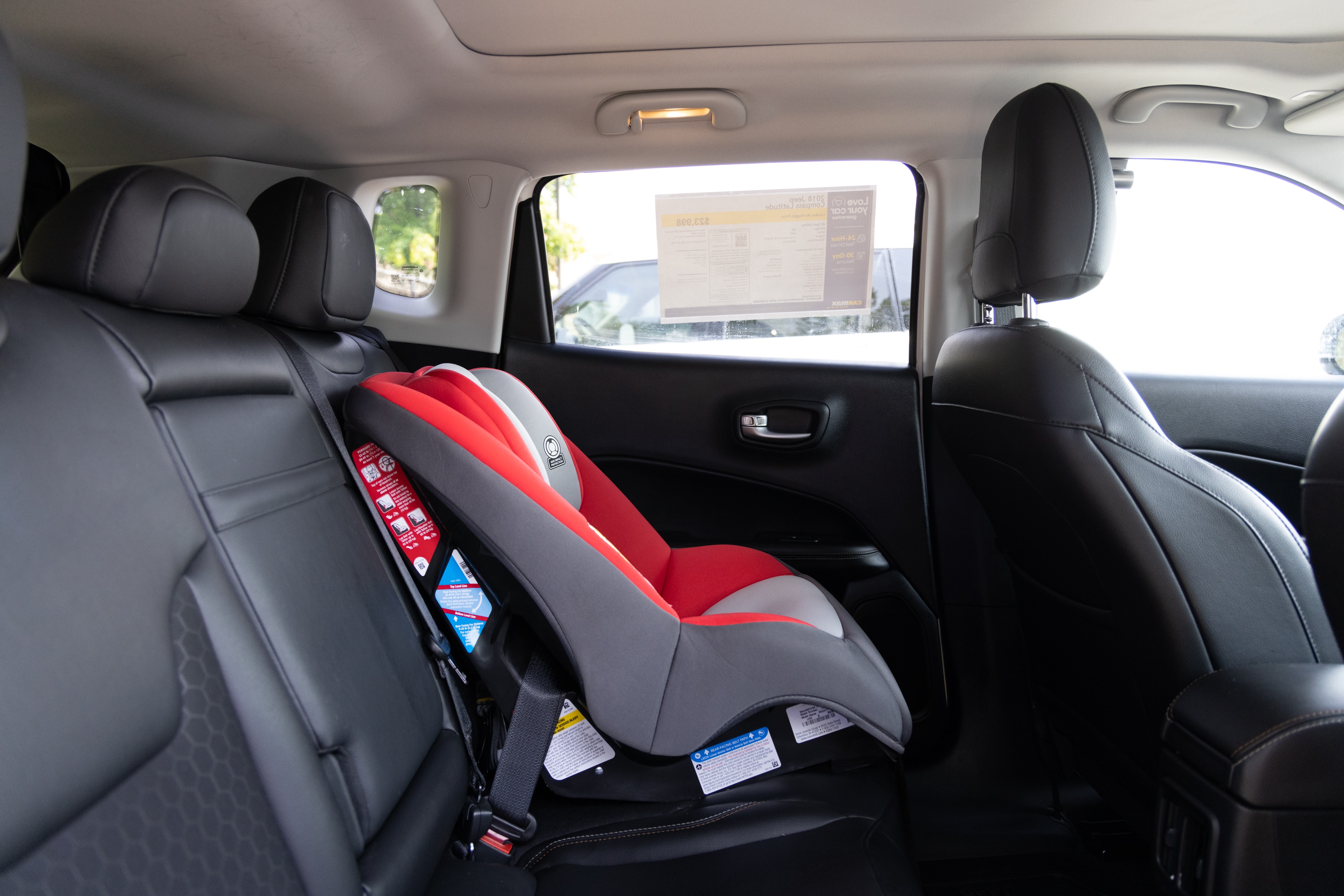 A series of second-row backseat photos is shown including one seating a baby seat and one seating a 6'1" mannequin.