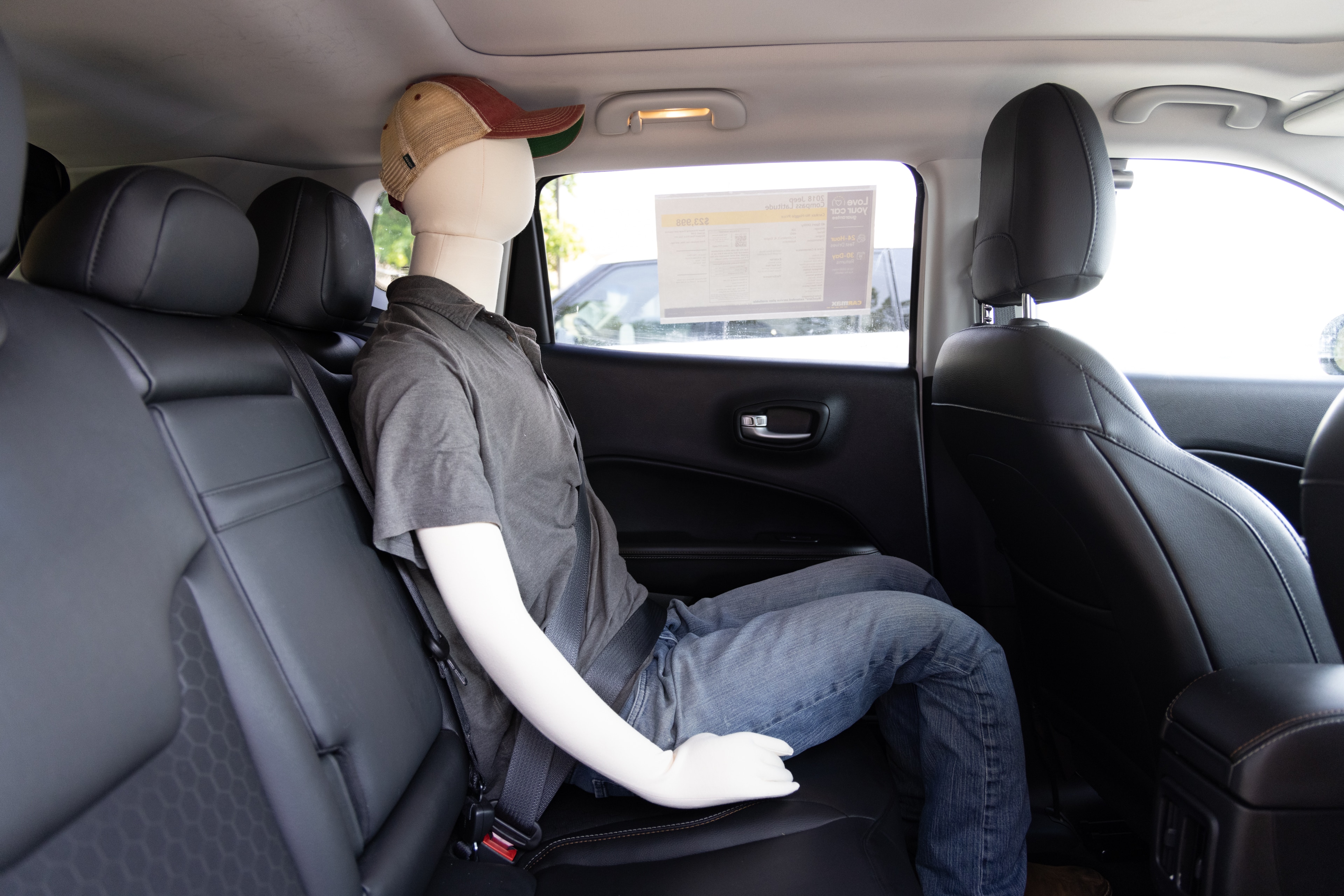 A series of second-row backseat photos is shown including one seating a baby seat and one seating a 6'1" mannequin.