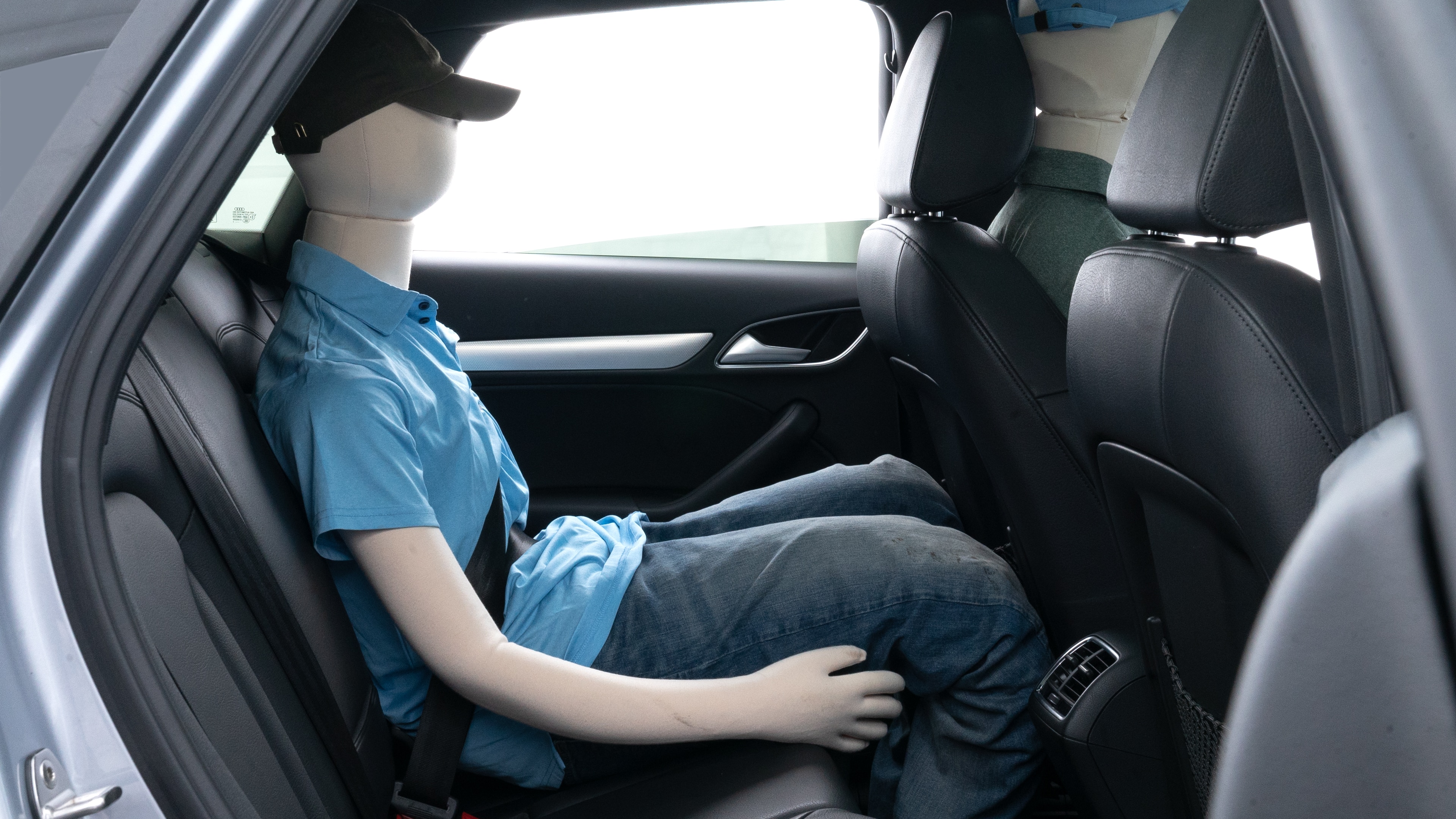 A series of second-row backseat photos is shown including one seating a baby seat and one seating a 6'1" mannequin.