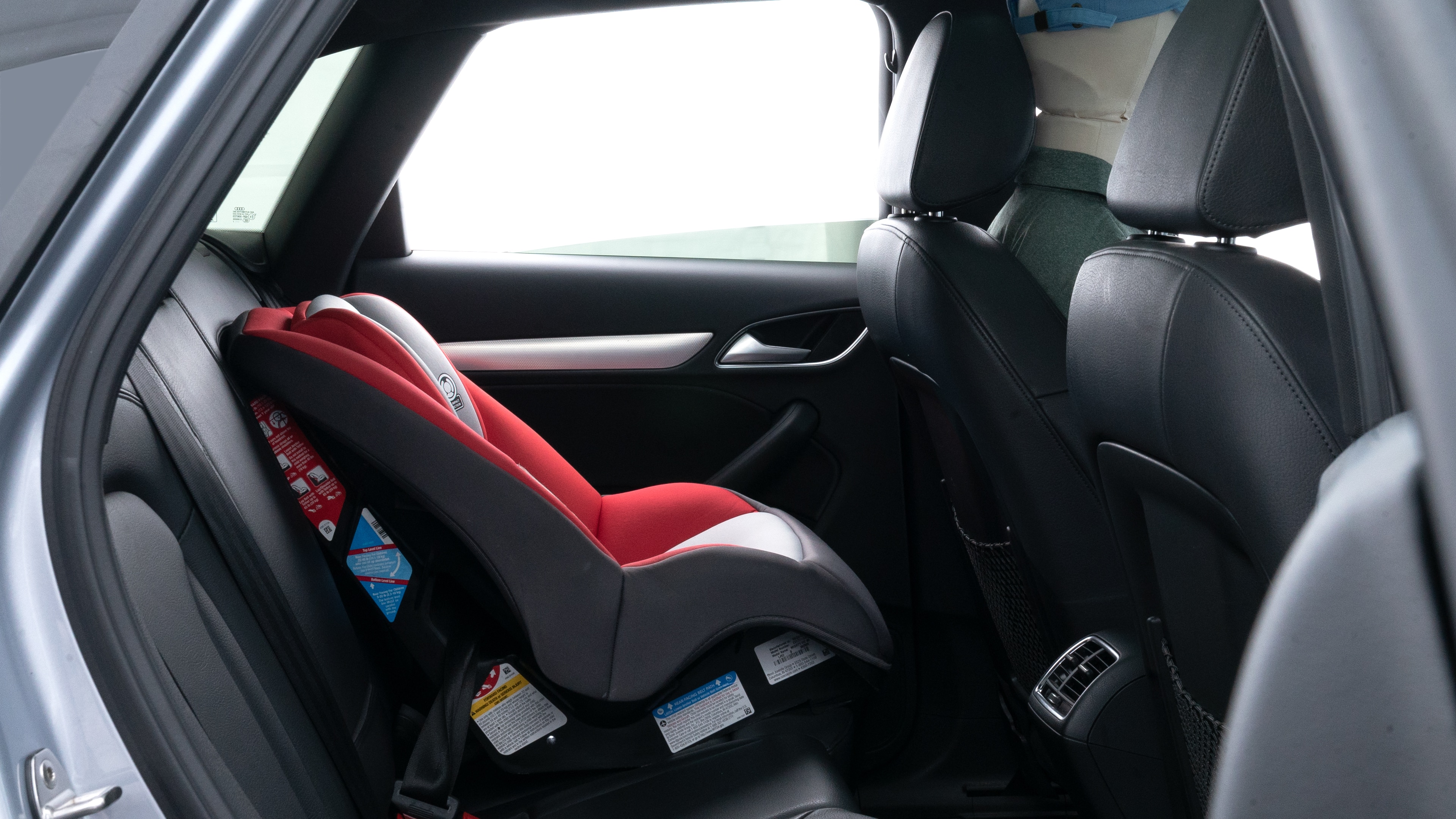 A series of second-row backseat photos is shown including one seating a baby seat and one seating a 6'1" mannequin.