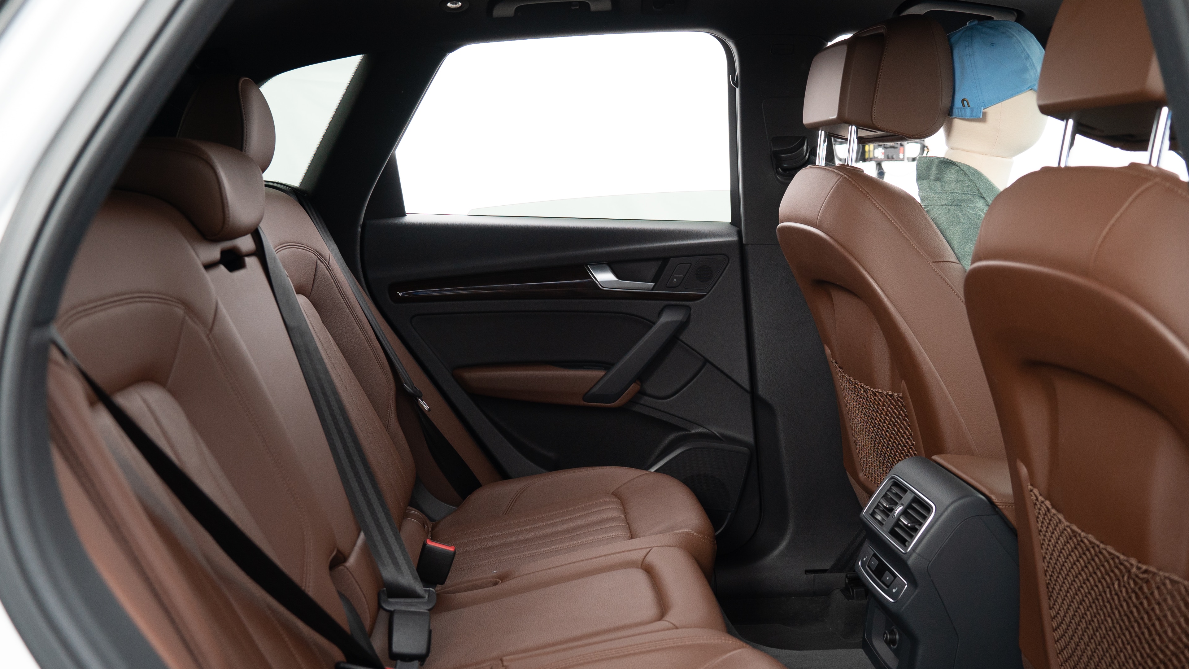 A series of second-row backseat photos is shown including one seating a baby seat, a dog and one seating a 6'1" mannequin.