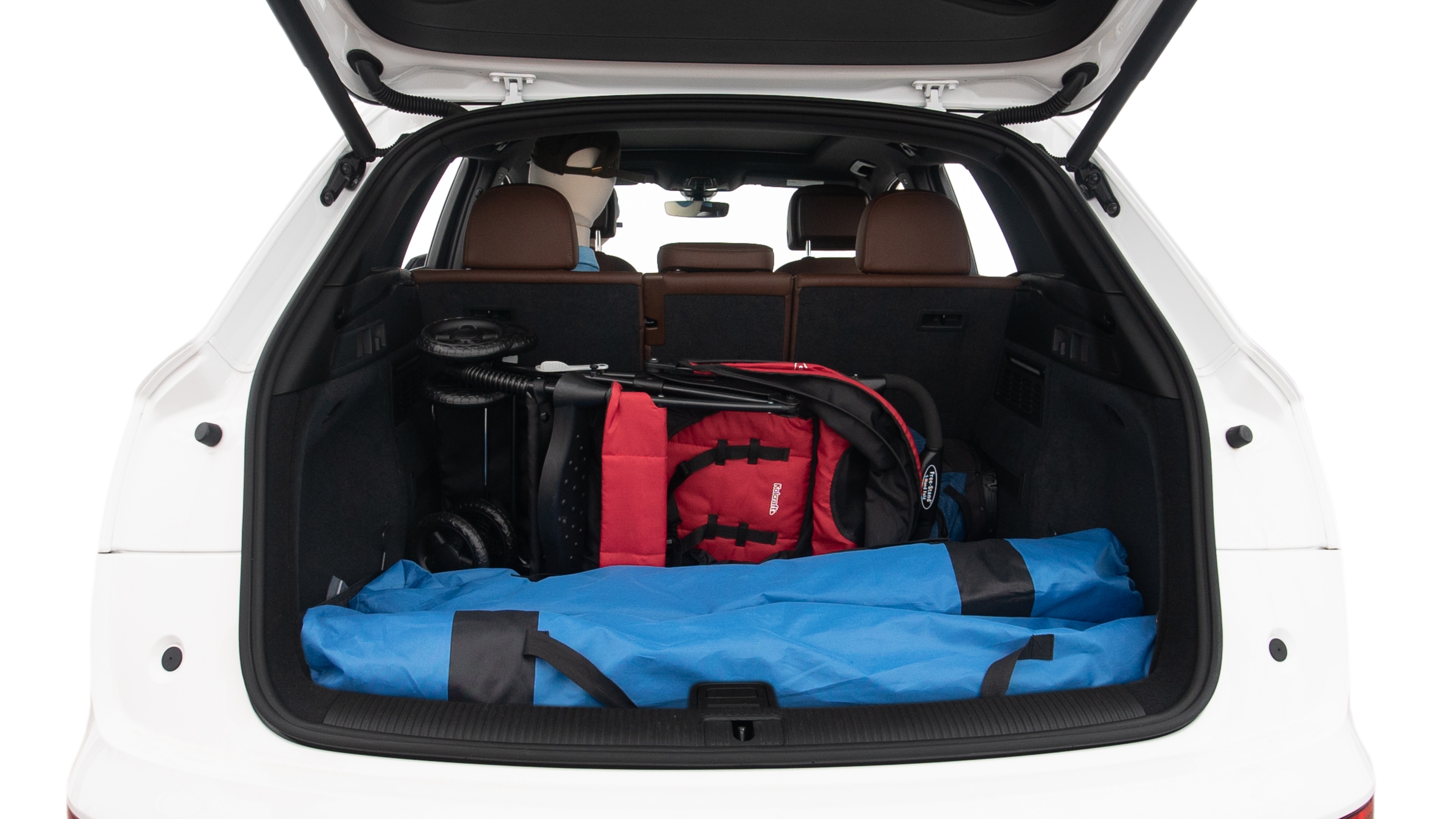 The trunk lid is open showing full view of the trunk. A baby stroller, three grocery carriers, two camping chairs in the carrying bag, and a set of golf clubs are placed inside.