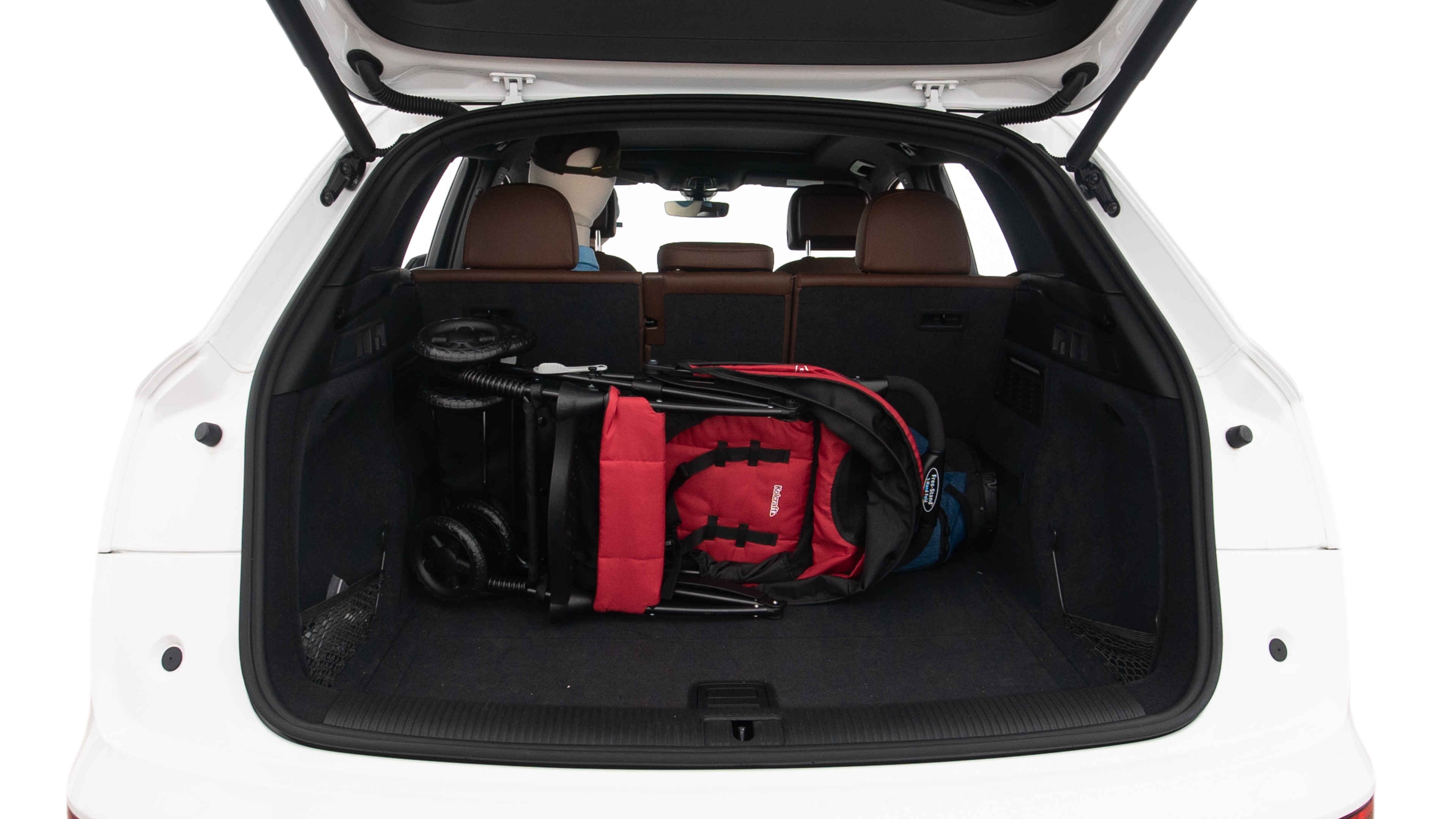 The trunk lid is open showing full view of the trunk. A baby stroller, three grocery carriers, two camping chairs in the carrying bag, and a set of golf clubs are placed inside.