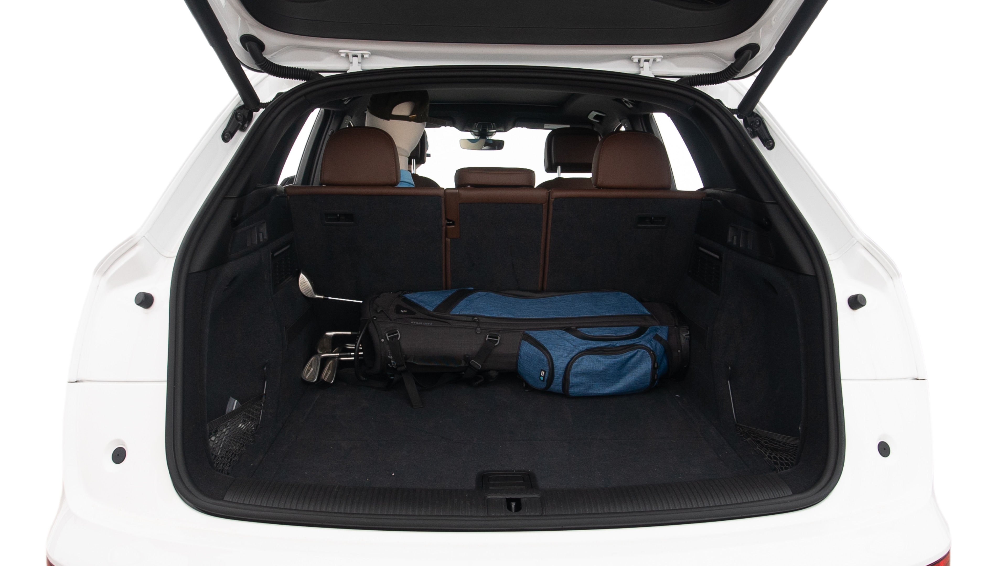 The trunk lid is open showing full view of the trunk. A baby stroller, three grocery carriers, two camping chairs in the carrying bag, and a set of golf clubs are placed inside.