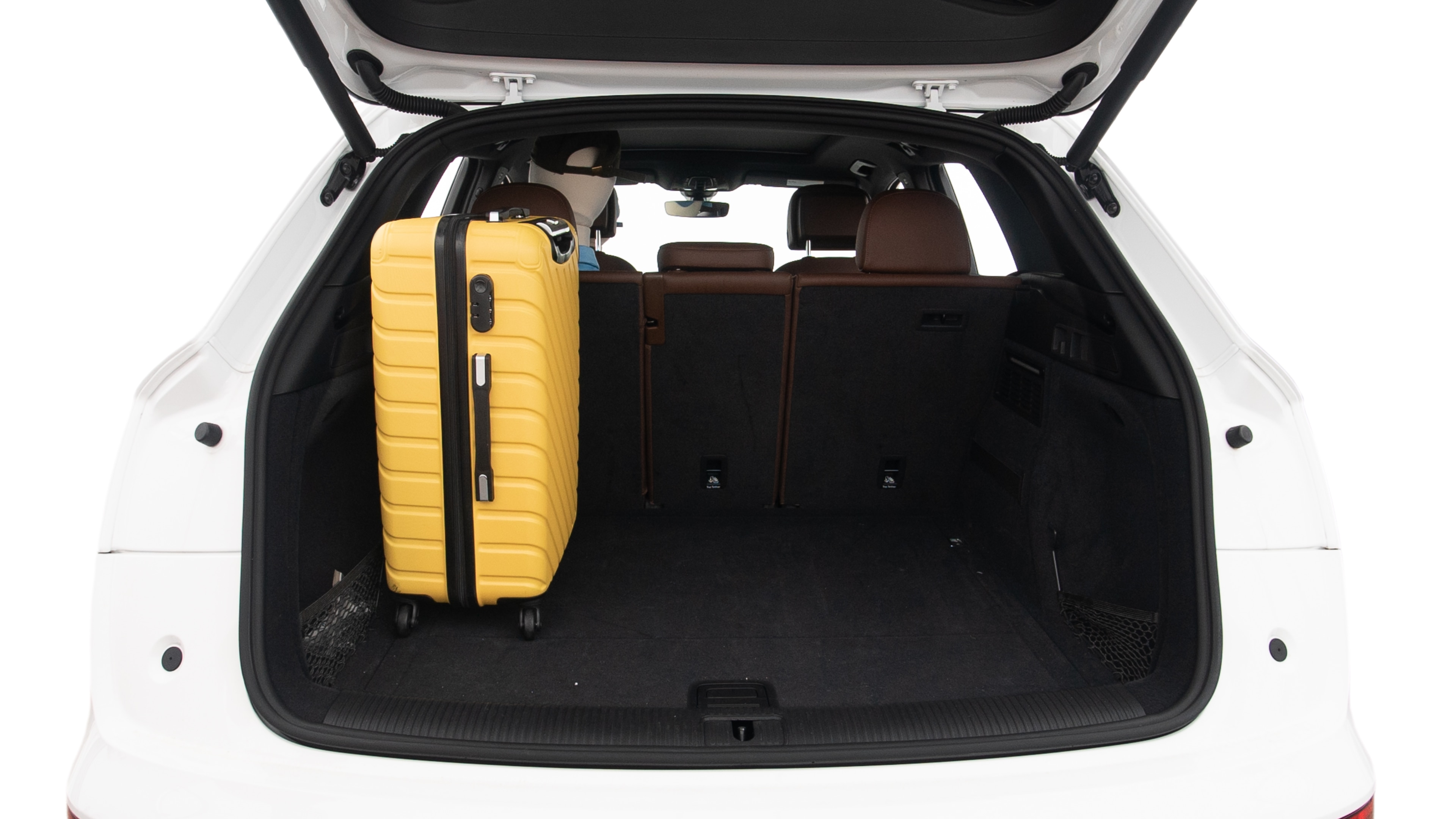 The trunk lid is open, showing full view of the trunk space. Two large and two small suitcases are placed inside.