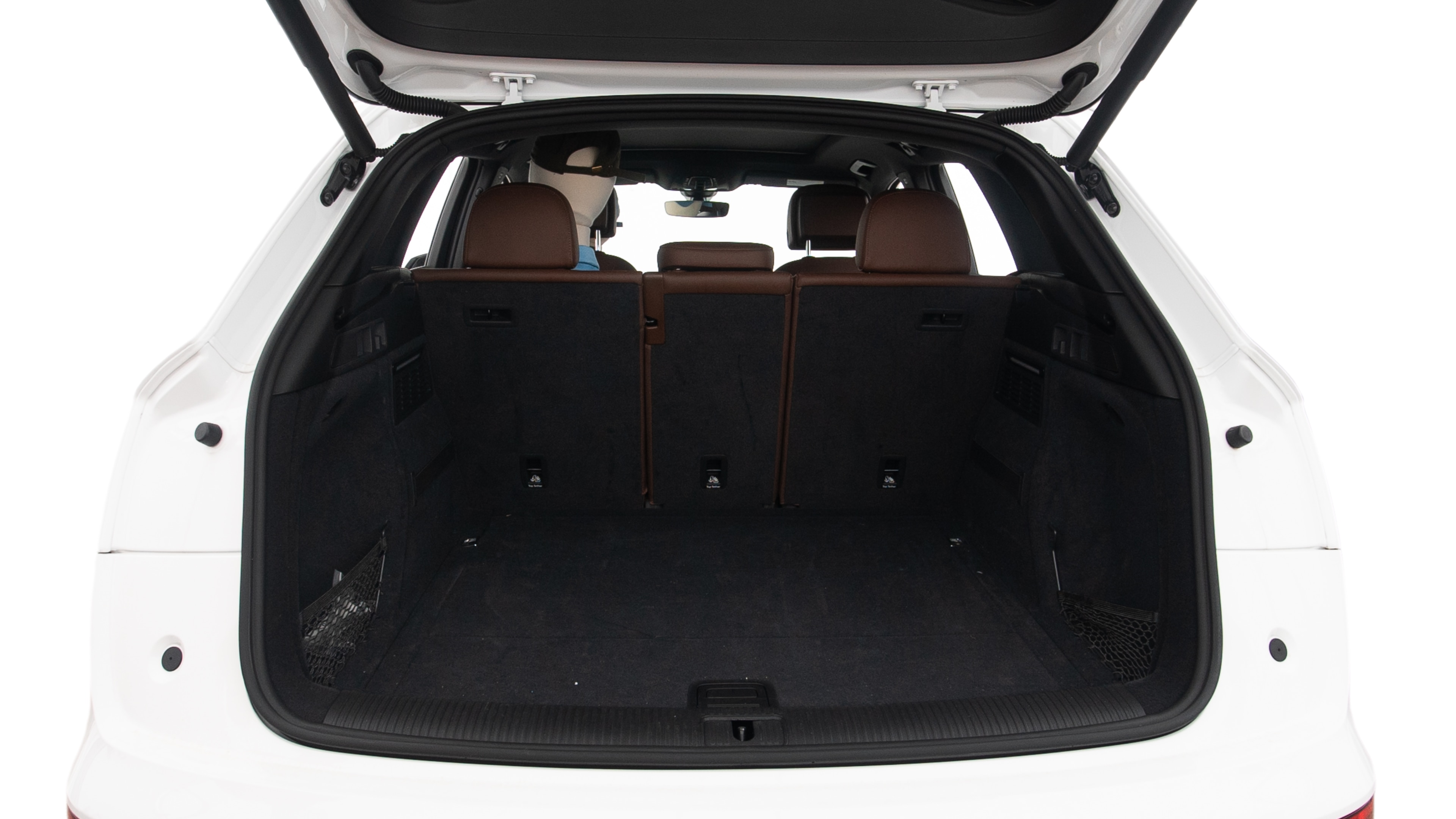 The trunk lid is open, showing full view of the trunk space. Two large and two small suitcases are placed inside.