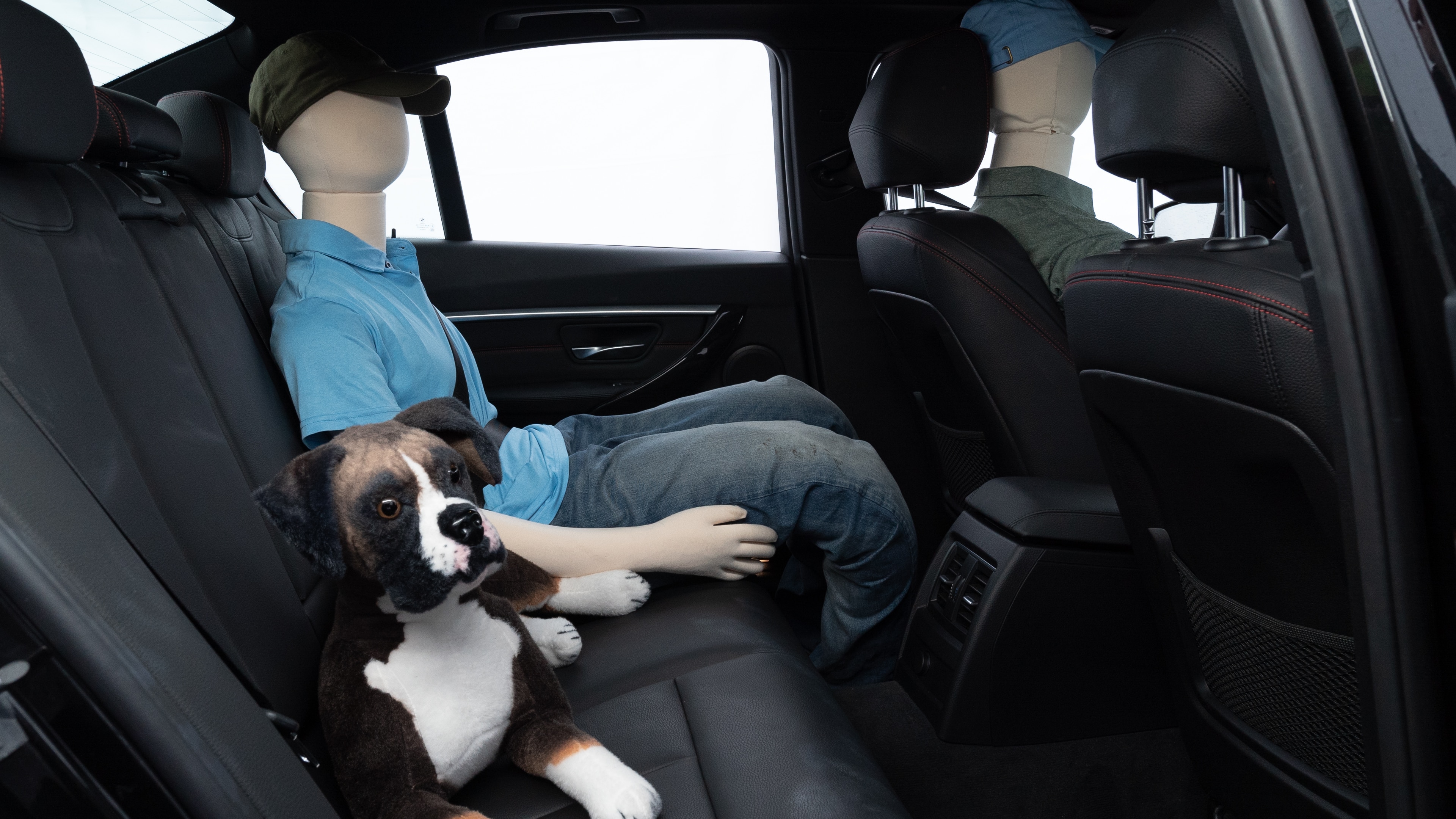 A series of second-row backseat photos is shown including one seating a baby seat and one seating a 6'1" mannequin.