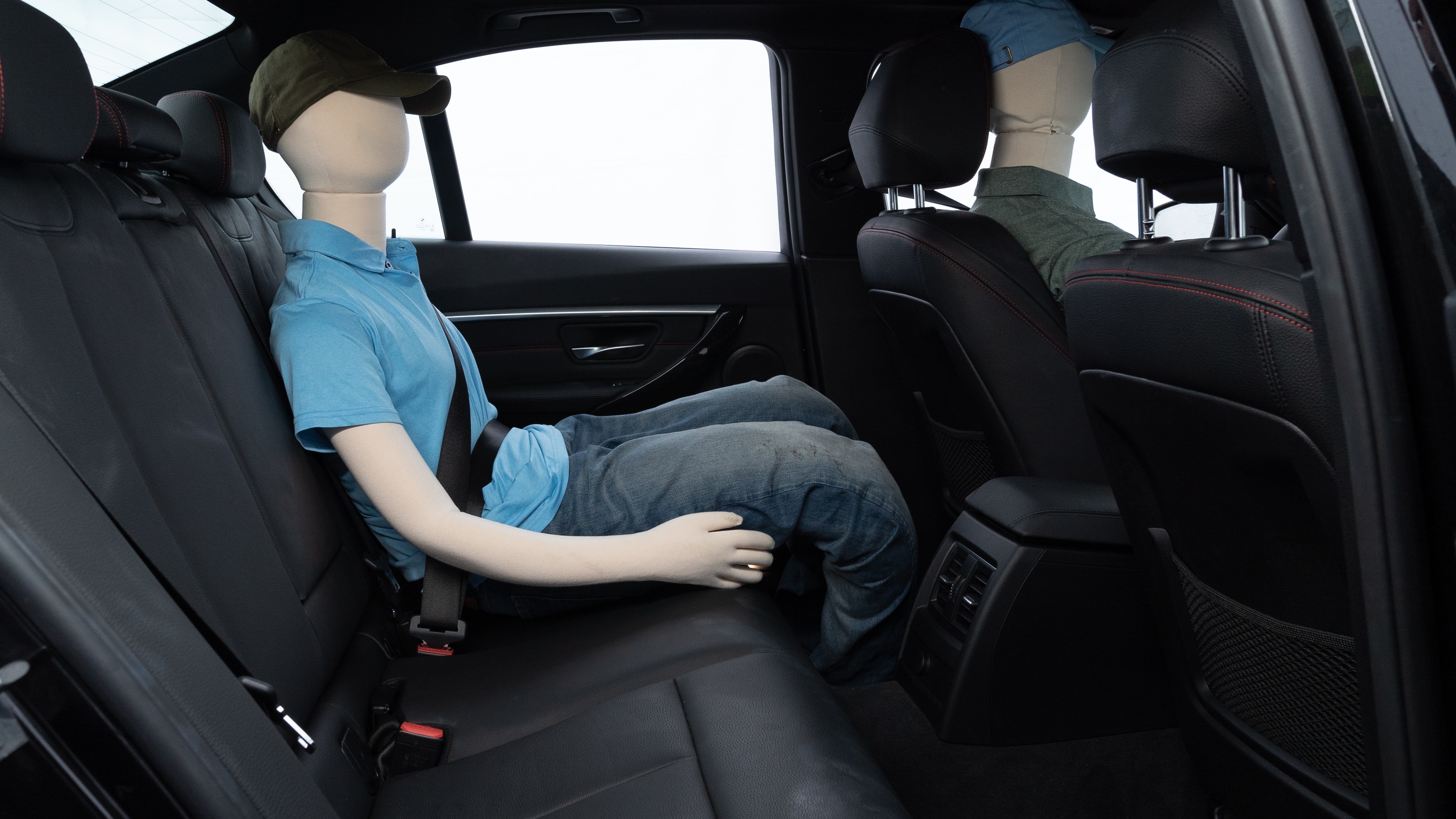A series of second-row backseat photos is shown including one seating a baby seat and one seating a 6'1" mannequin.