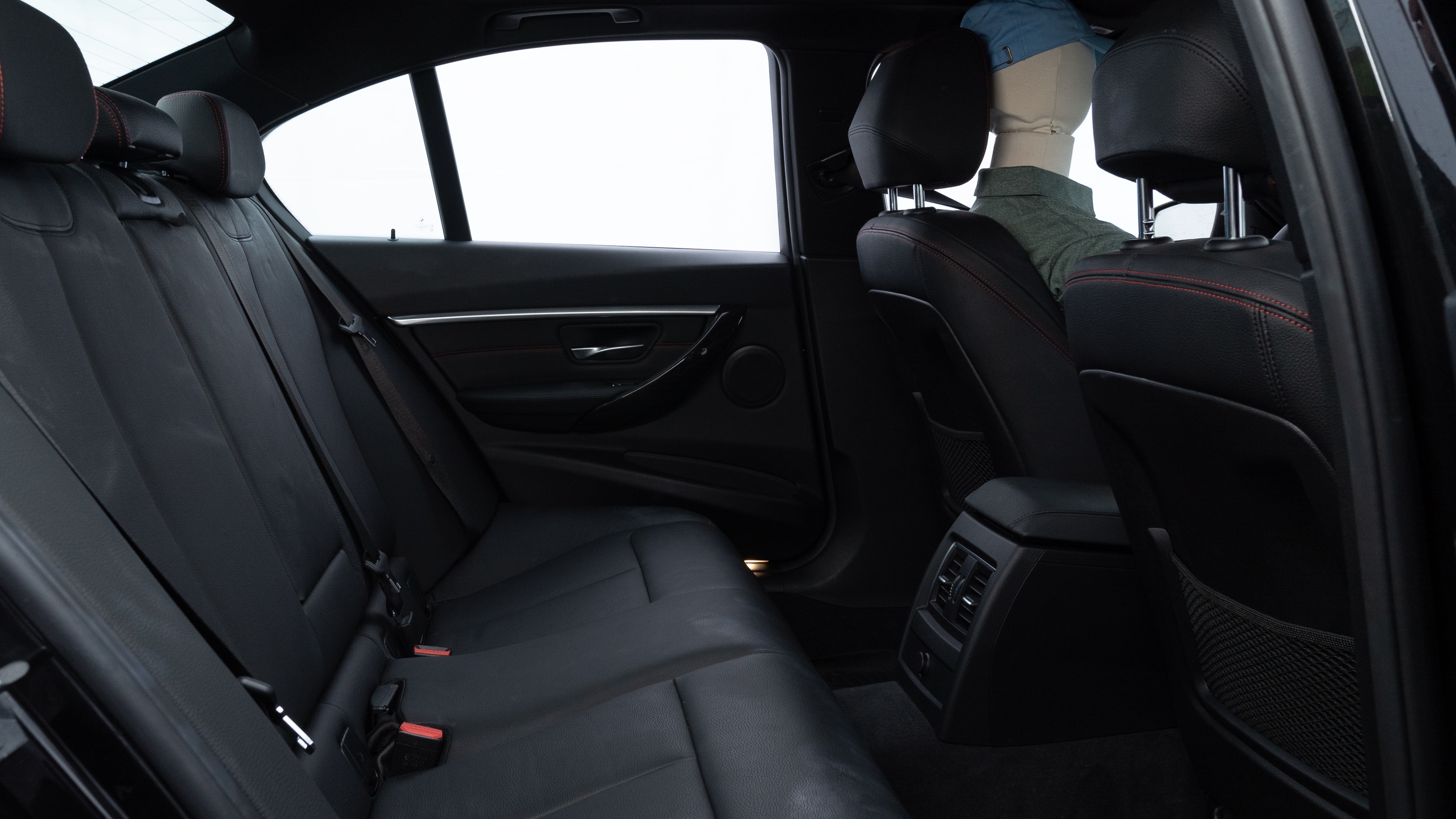 A series of second-row backseat photos is shown including one seating a baby seat and one seating a 6'1" mannequin.