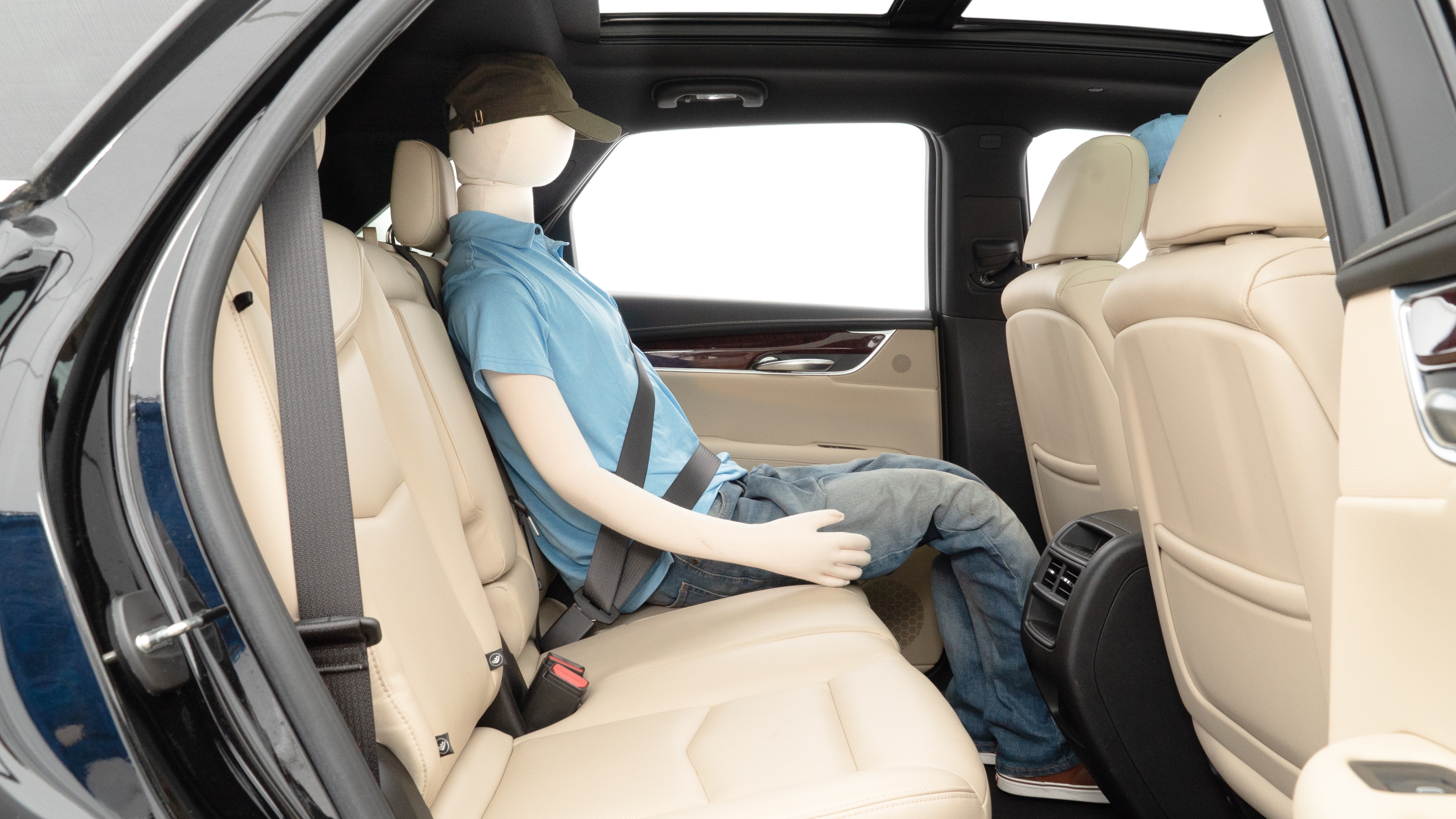 A series of second-row backseat photos is shown including one seating a baby seat and one seating a 6'1" mannequin.