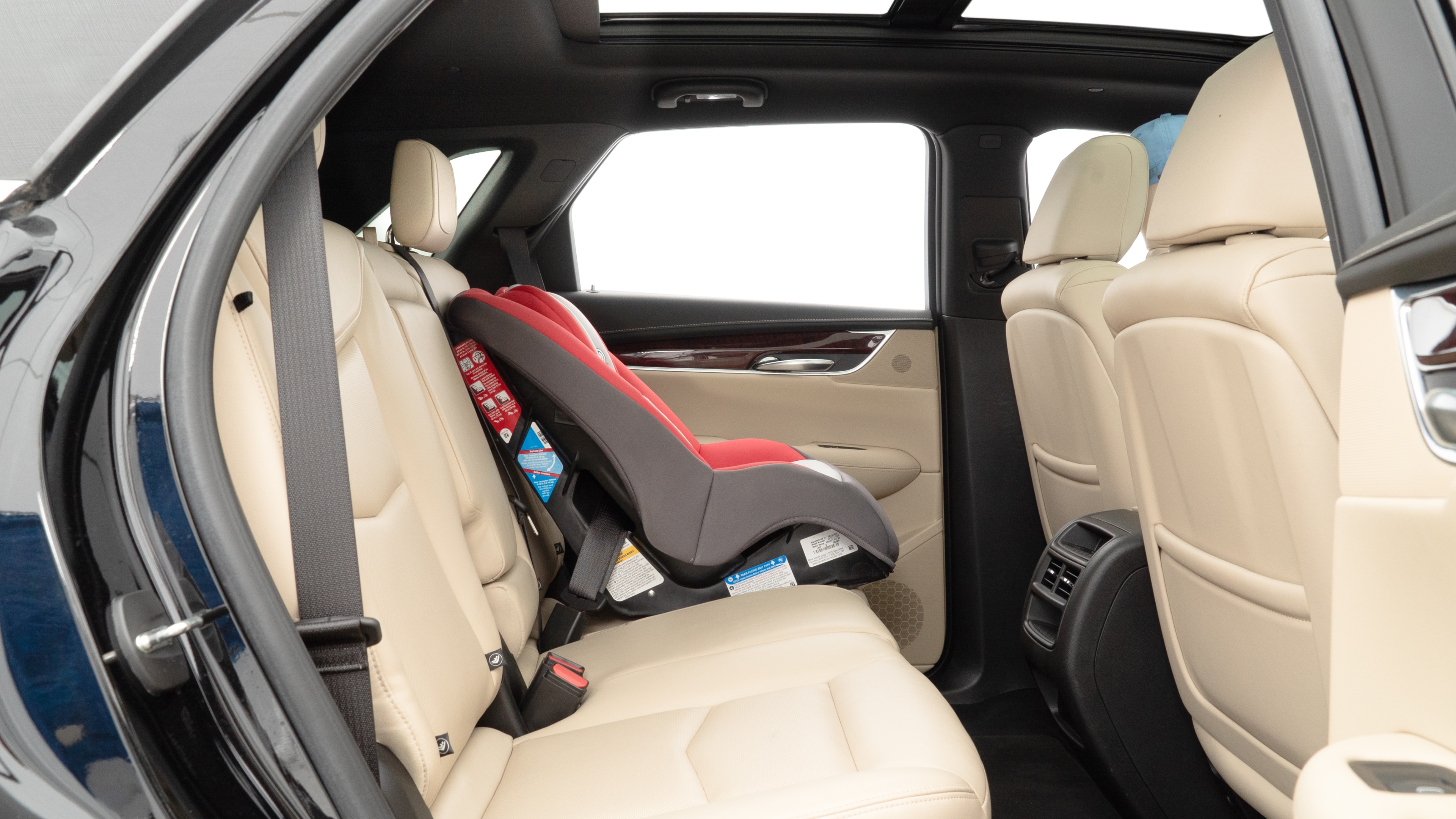 A series of second-row backseat photos is shown including one seating a baby seat and one seating a 6'1" mannequin.
