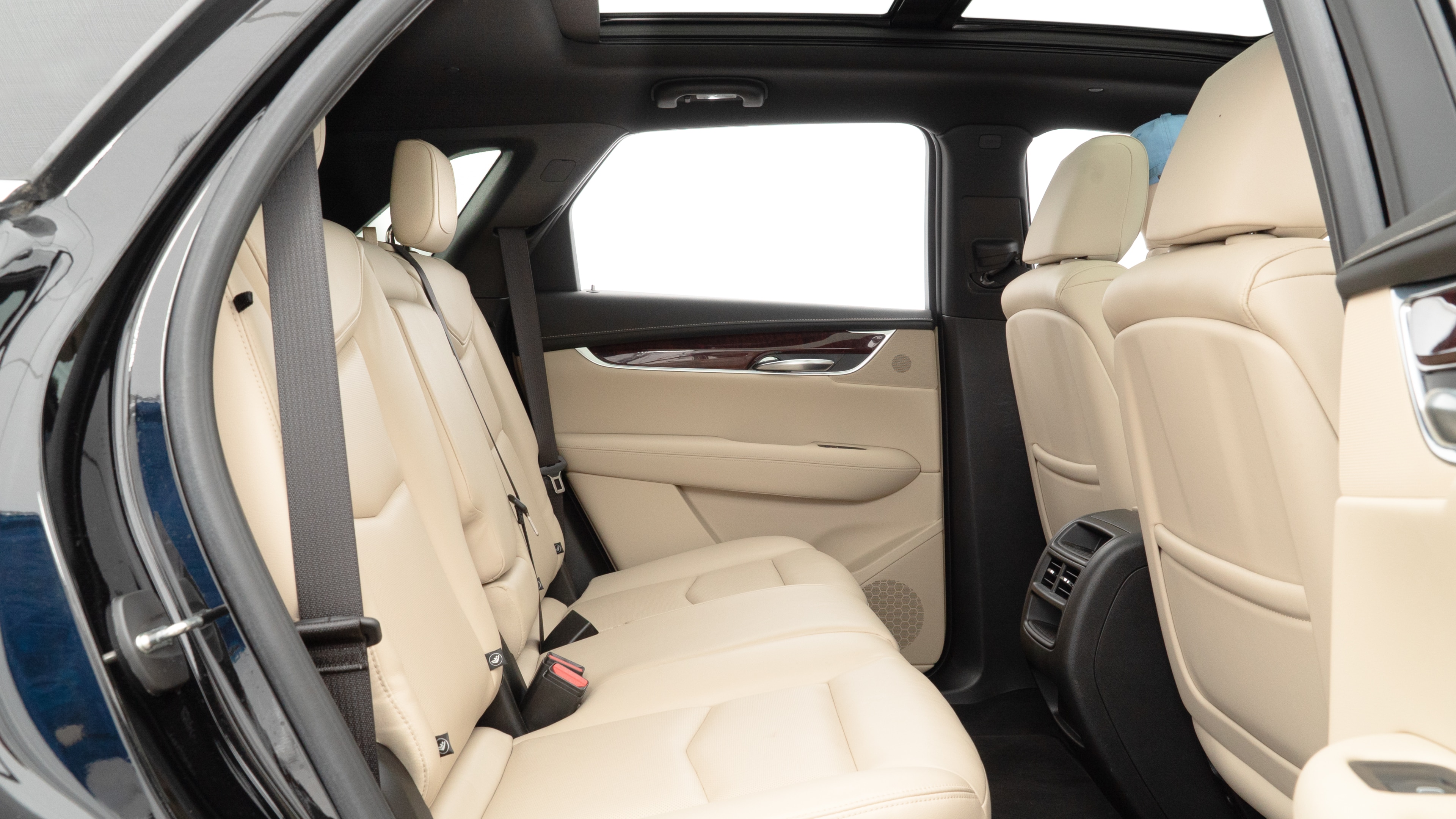 A series of second-row backseat photos is shown including one seating a baby seat and one seating a 6'1" mannequin.