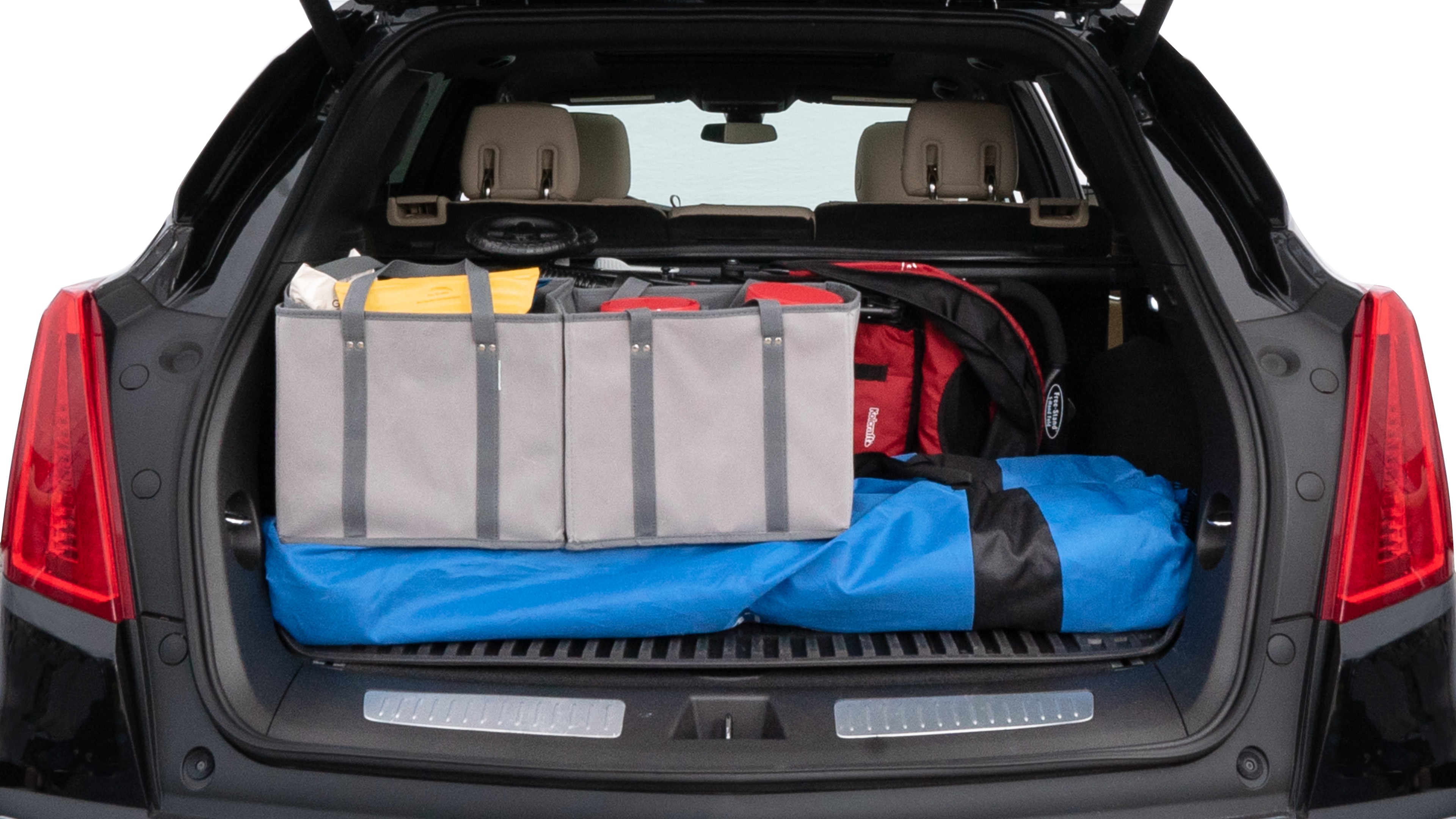 The trunk lid is open showing full view of the trunk. A baby stroller, three grocery carriers, two camping chairs in the carrying bag, and a set of golf clubs are placed inside.