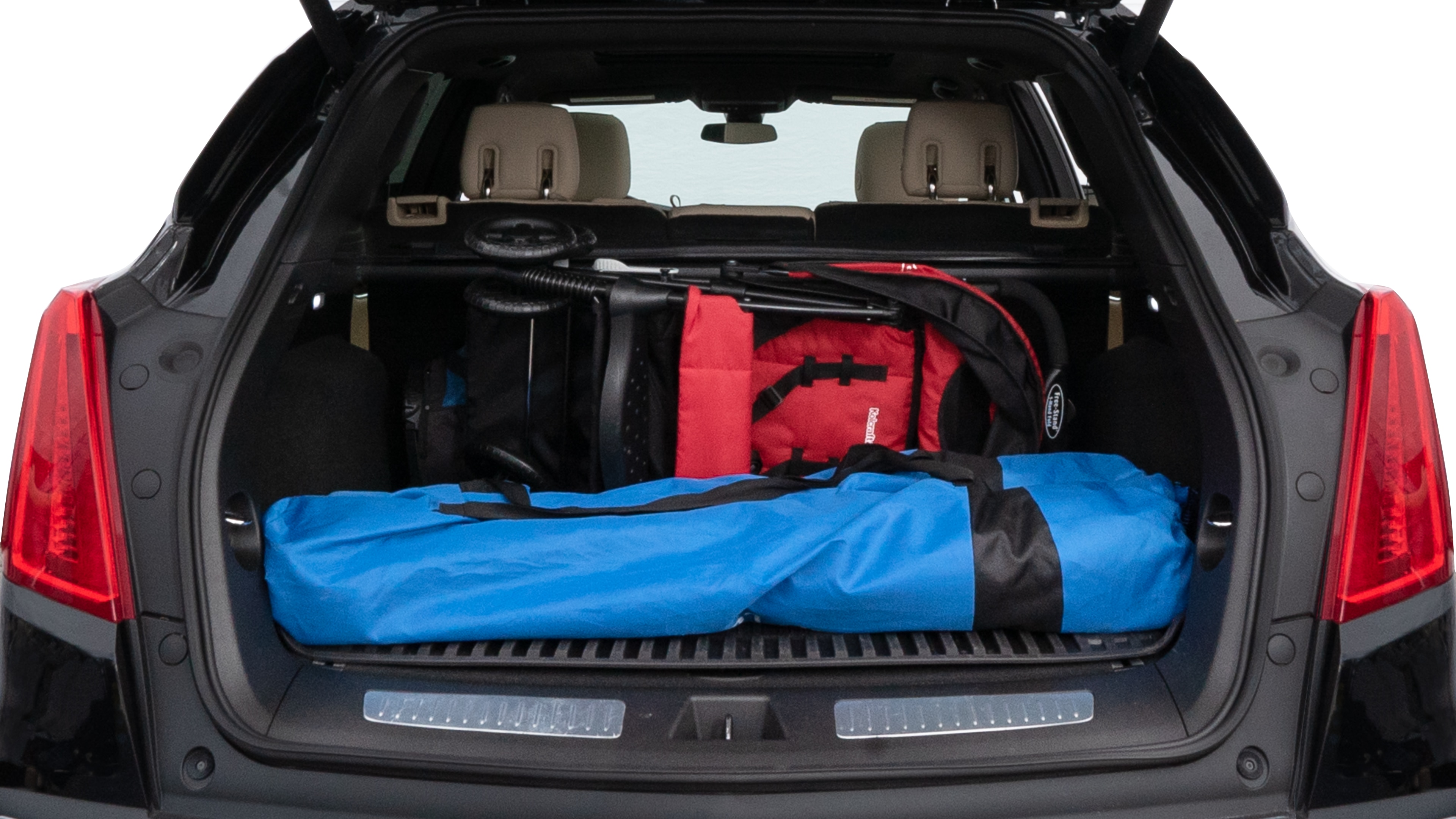 The trunk lid is open showing full view of the trunk. A baby stroller, three grocery carriers, two camping chairs in the carrying bag, and a set of golf clubs are placed inside.