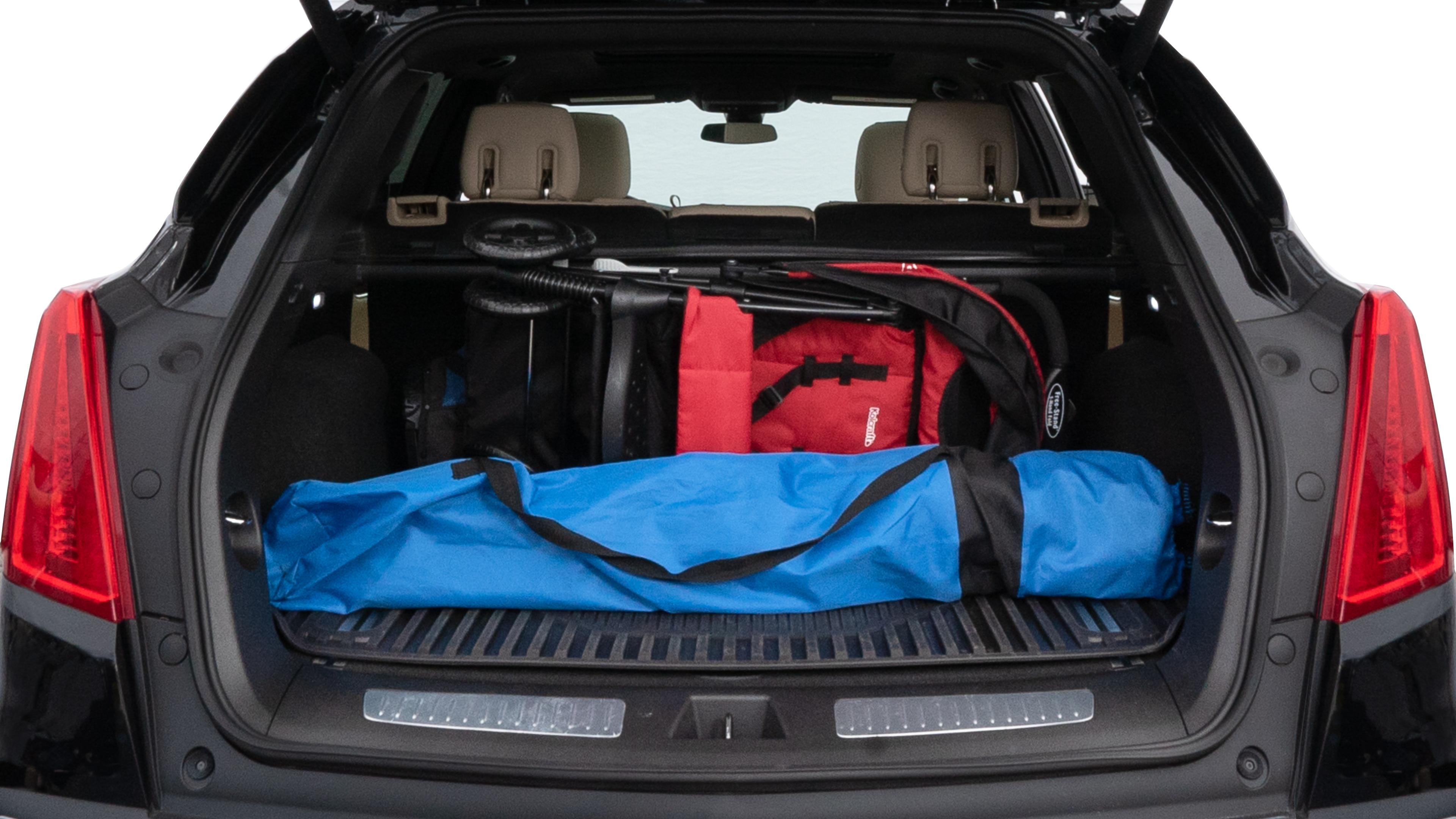 The trunk lid is open showing full view of the trunk. A baby stroller, three grocery carriers, two camping chairs in the carrying bag, and a set of golf clubs are placed inside.