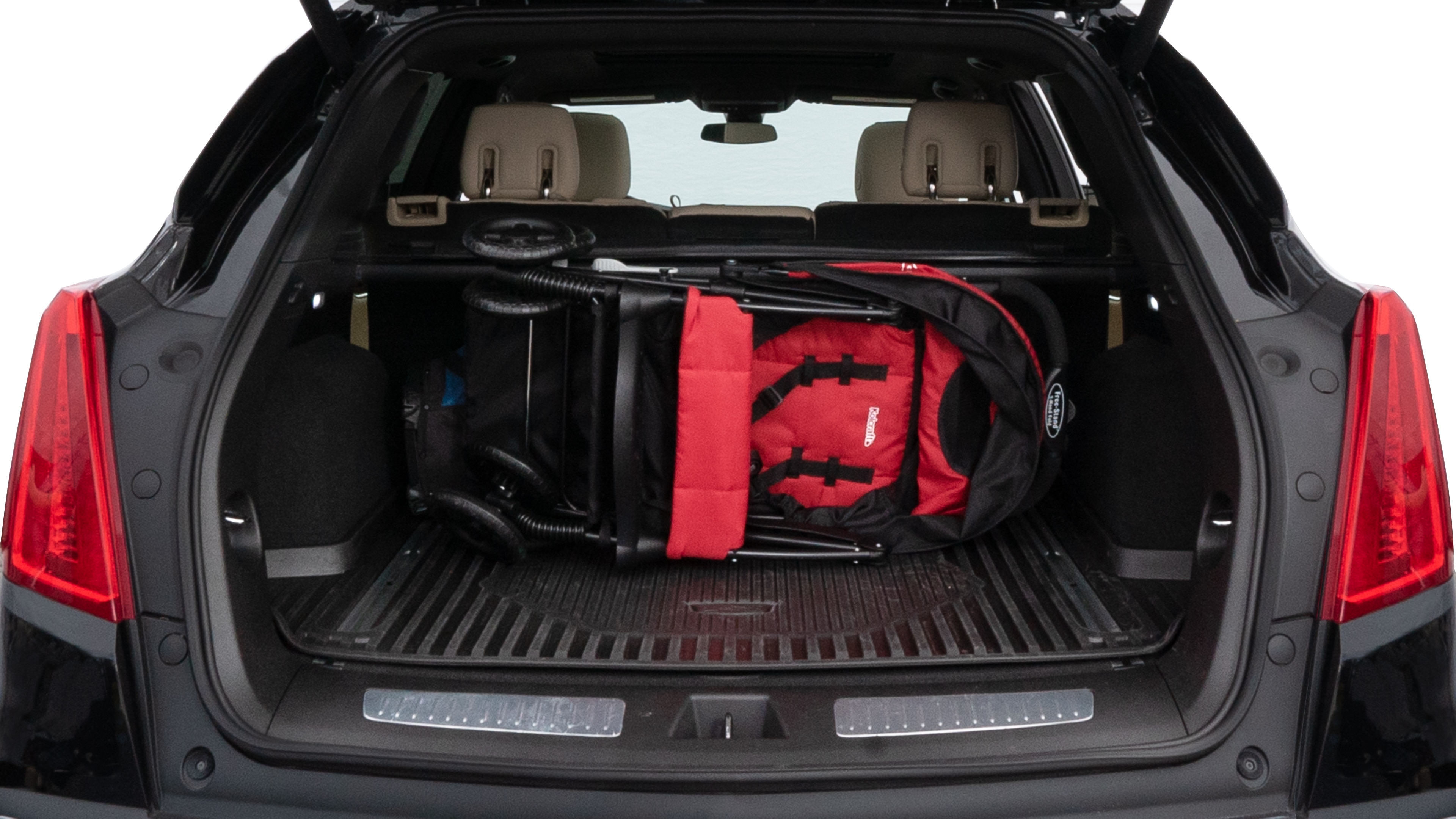 The trunk lid is open showing full view of the trunk. A baby stroller, three grocery carriers, two camping chairs in the carrying bag, and a set of golf clubs are placed inside.