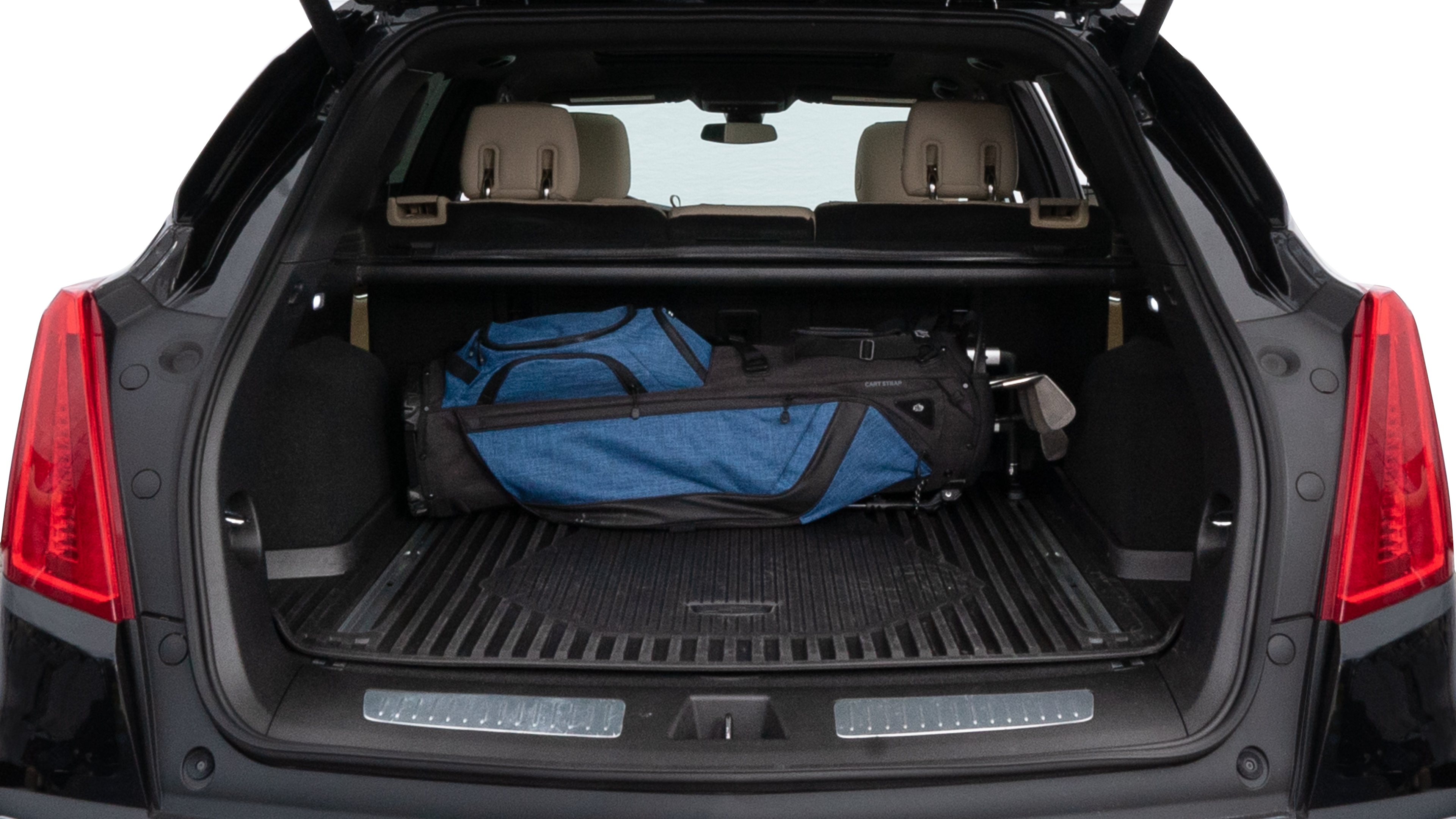 The trunk lid is open showing full view of the trunk. A baby stroller, three grocery carriers, two camping chairs in the carrying bag, and a set of golf clubs are placed inside.