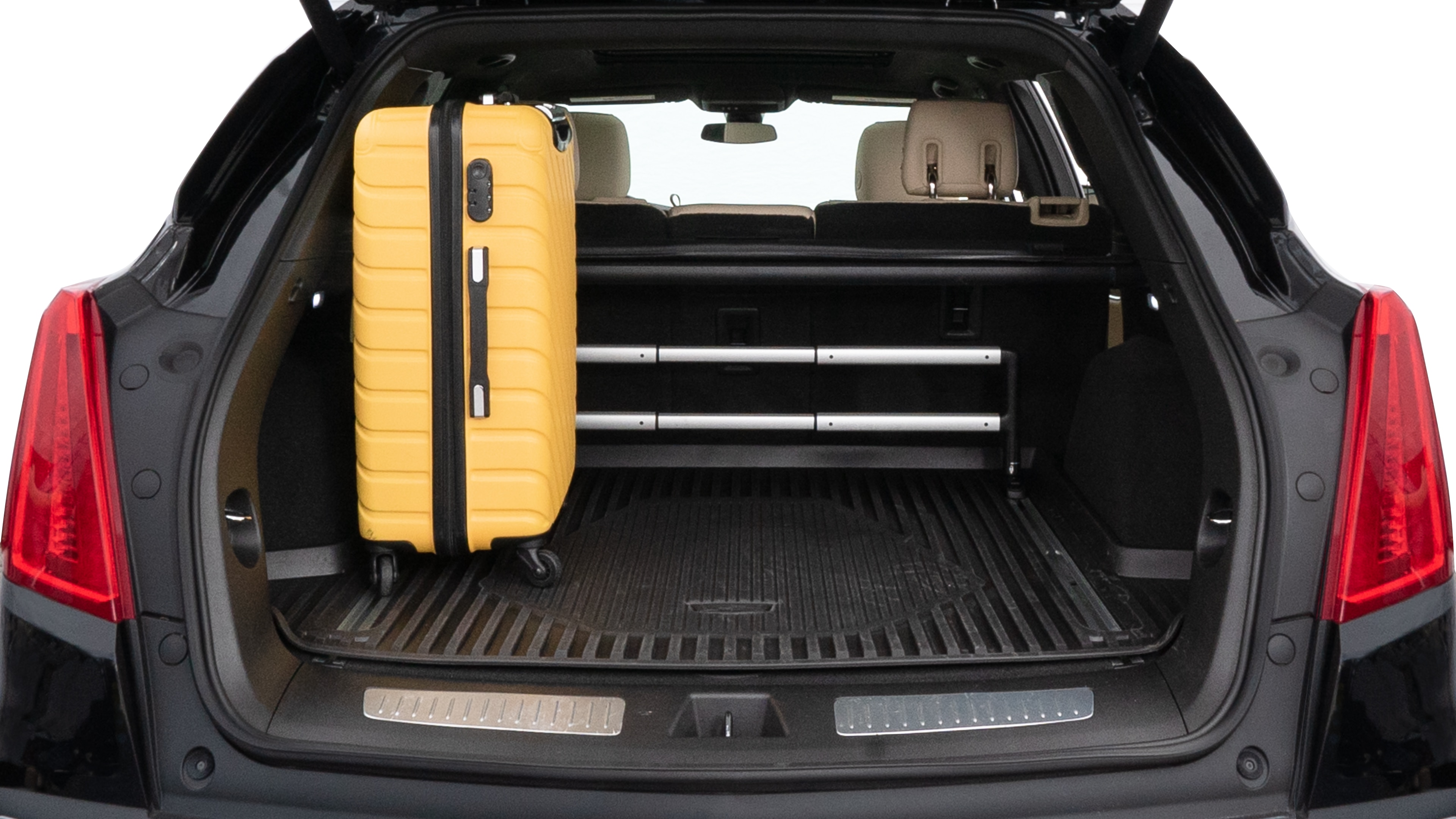 The trunk lid is open, showing full view of the trunk space. Two medium and two small suitcases are placed inside.