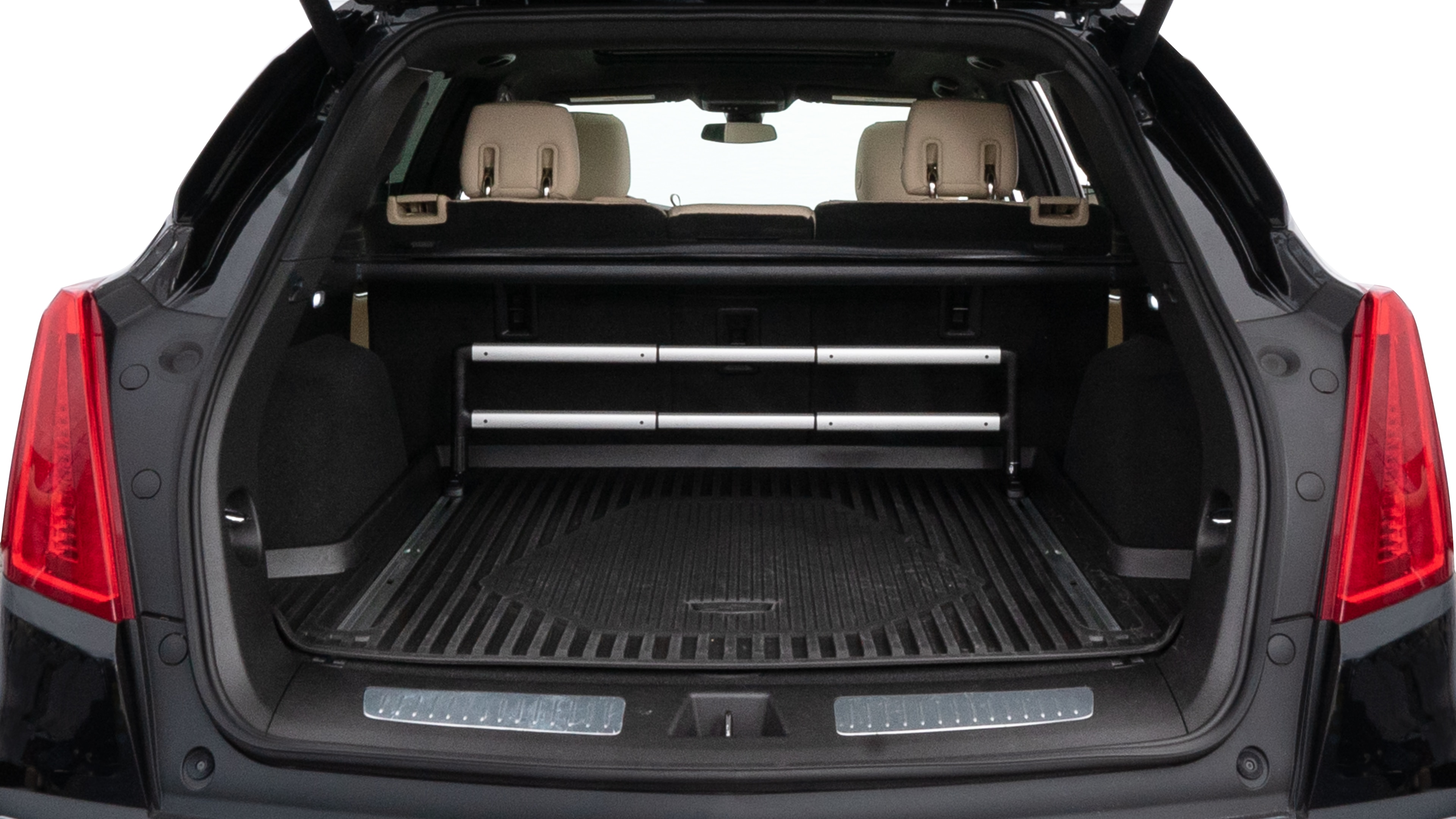 The trunk lid is open, showing full view of the trunk space. Two medium and two small suitcases are placed inside.