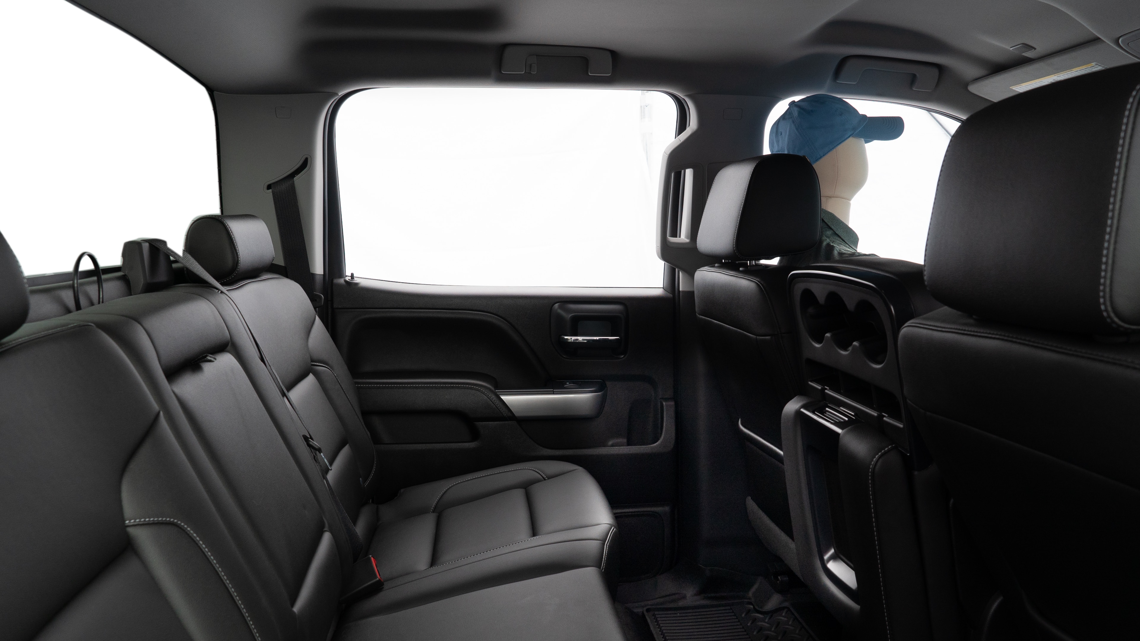 A series of second-row backseat photos is shown including one seating a baby seat and one seating a 6'1" mannequin.