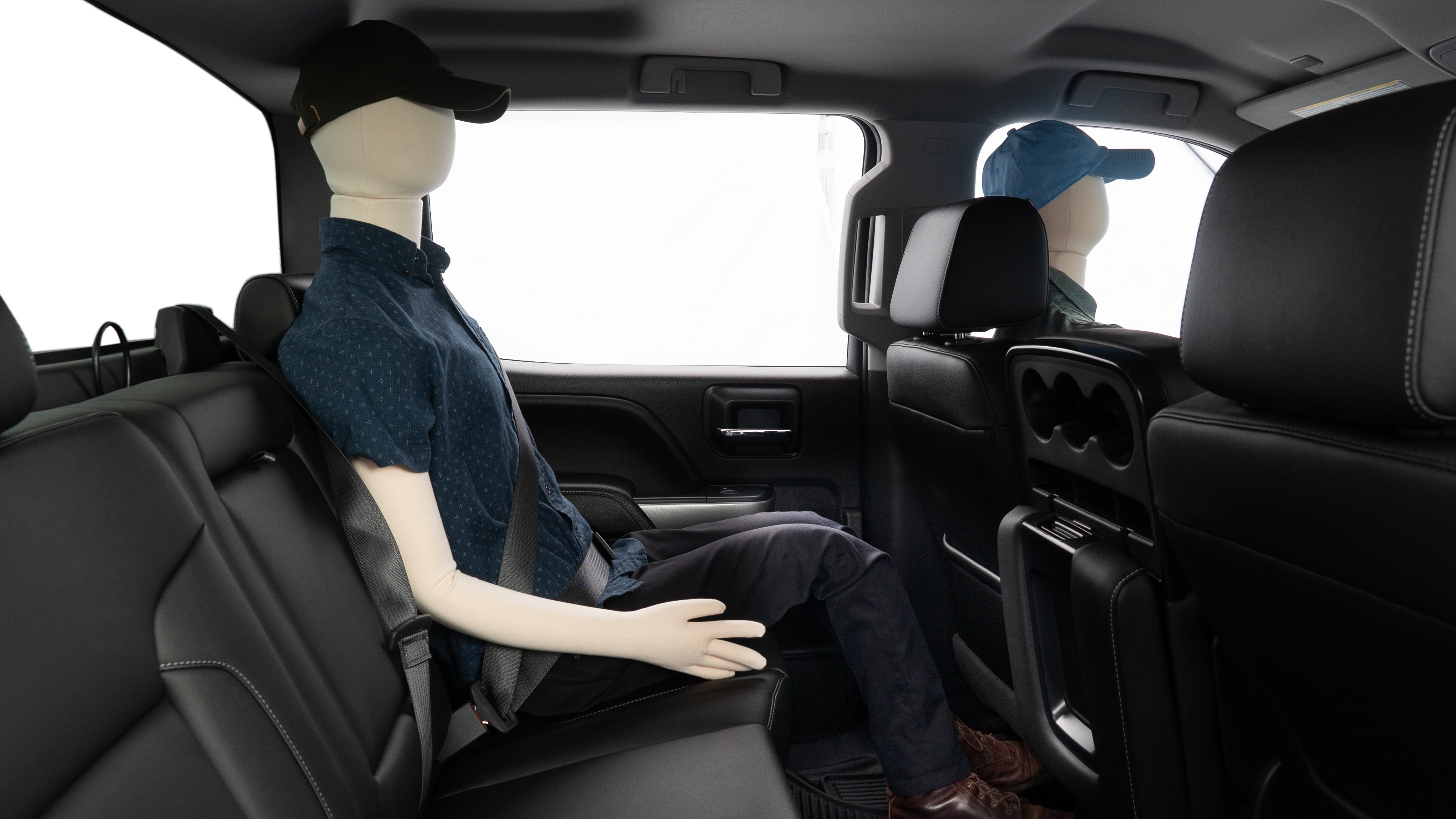 A series of second-row backseat photos is shown including one seating a baby seat and one seating a 6'1" mannequin.