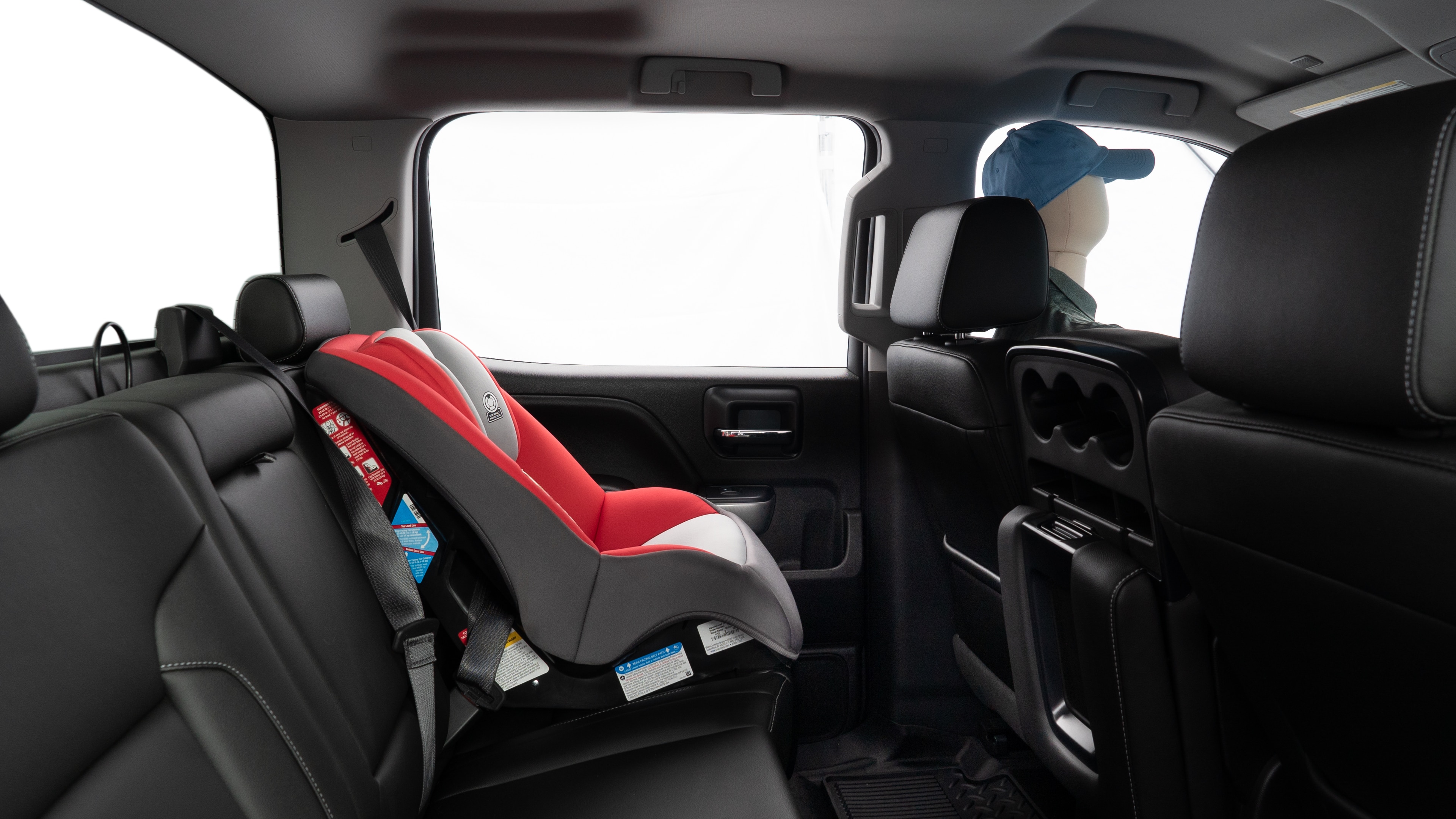 A series of second-row backseat photos is shown including one seating a baby seat and one seating a 6'1" mannequin.