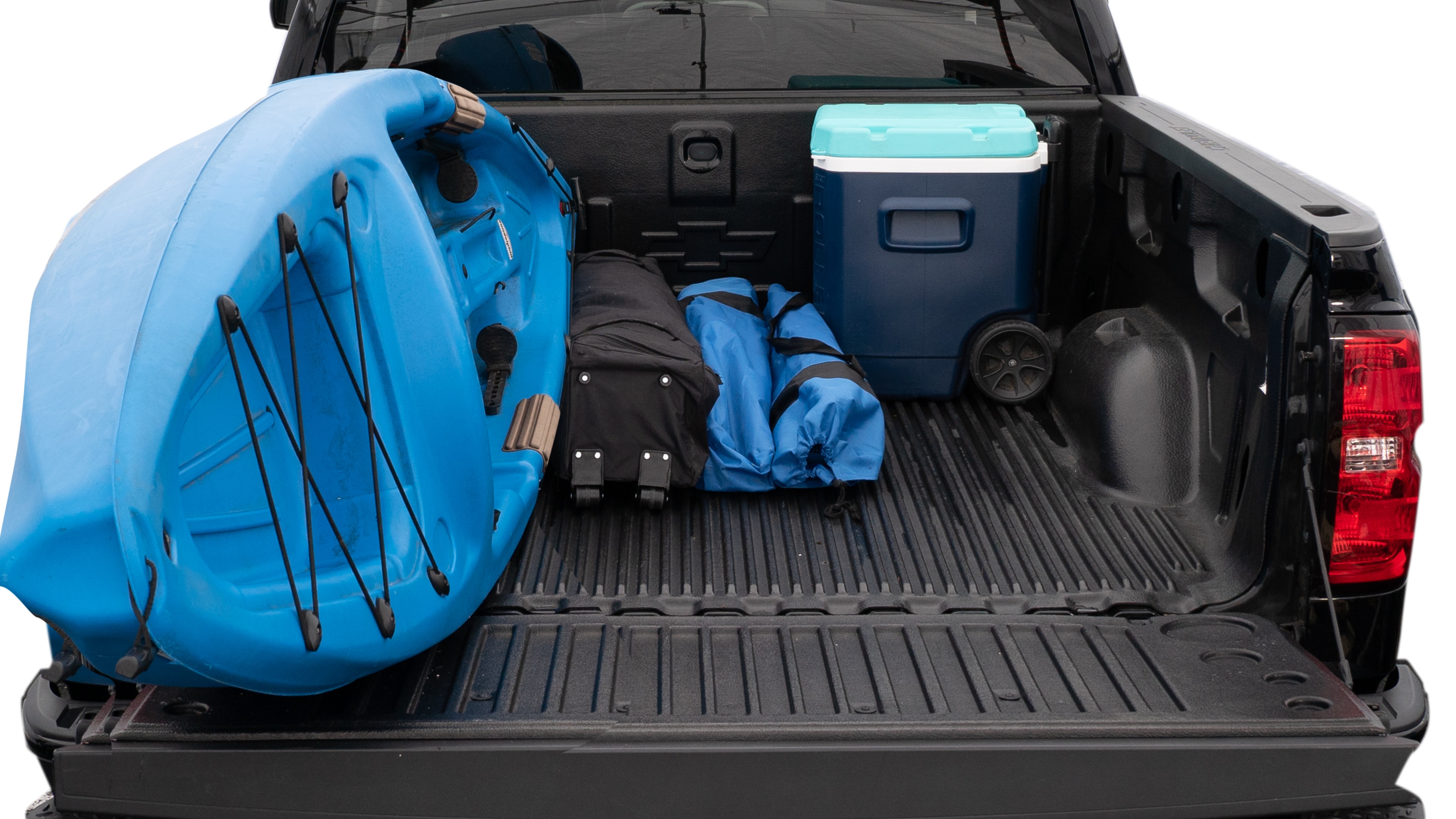 The trunk area is open giving a full view of the trunk area. A cooler, two camping chairs, a tailgate tent and a kayak are placed inside.