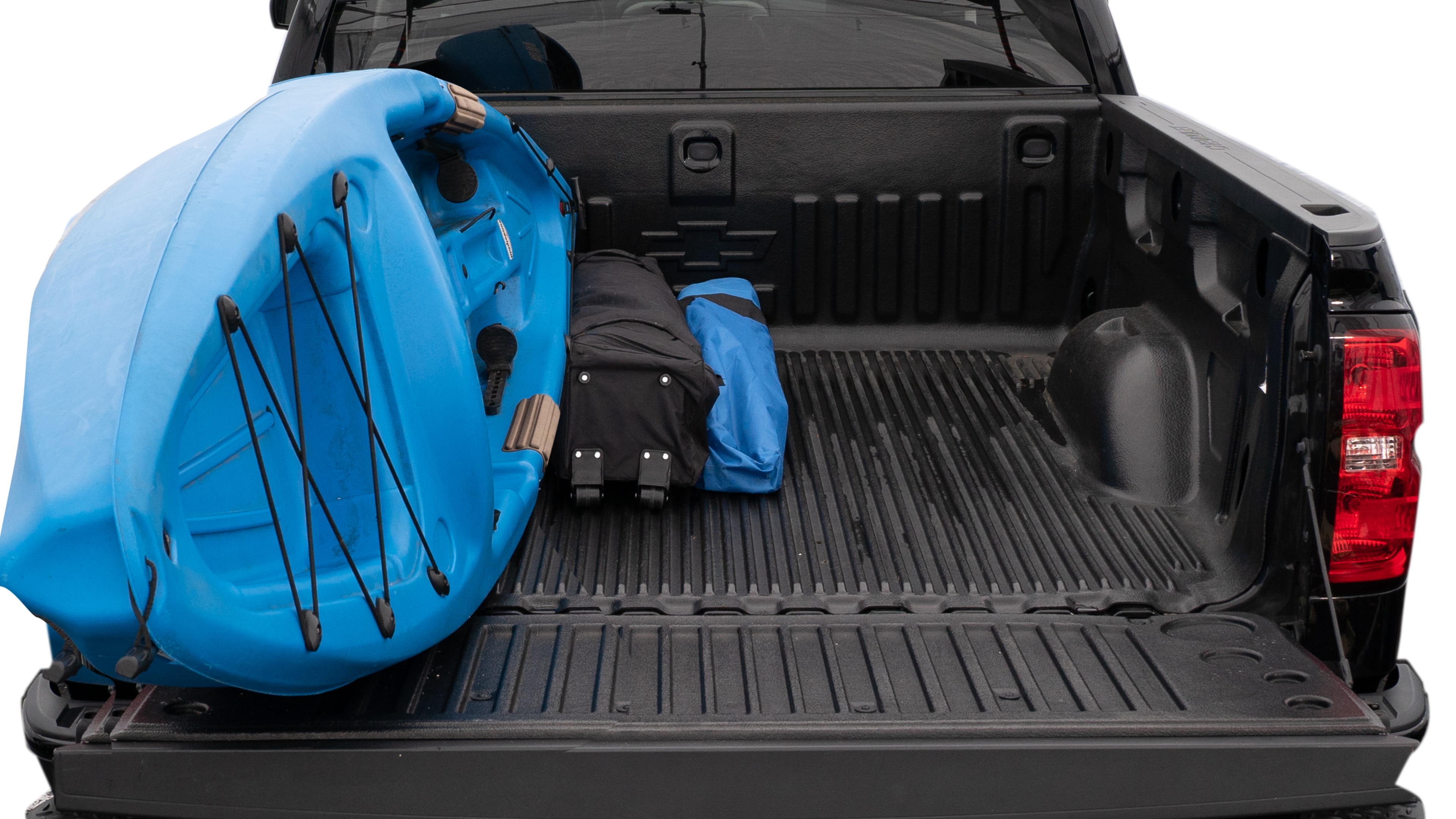 The trunk area is open giving a full view of the trunk area. A cooler, two camping chairs, a tailgate tent and a kayak are placed inside.
