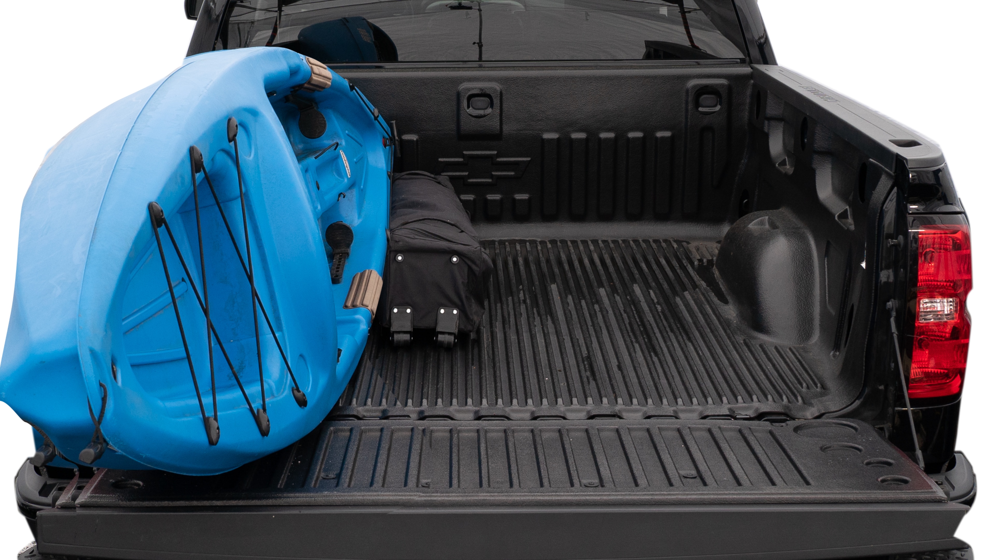 The trunk area is open giving a full view of the trunk area. A cooler, two camping chairs, a tailgate tent and a kayak are placed inside.