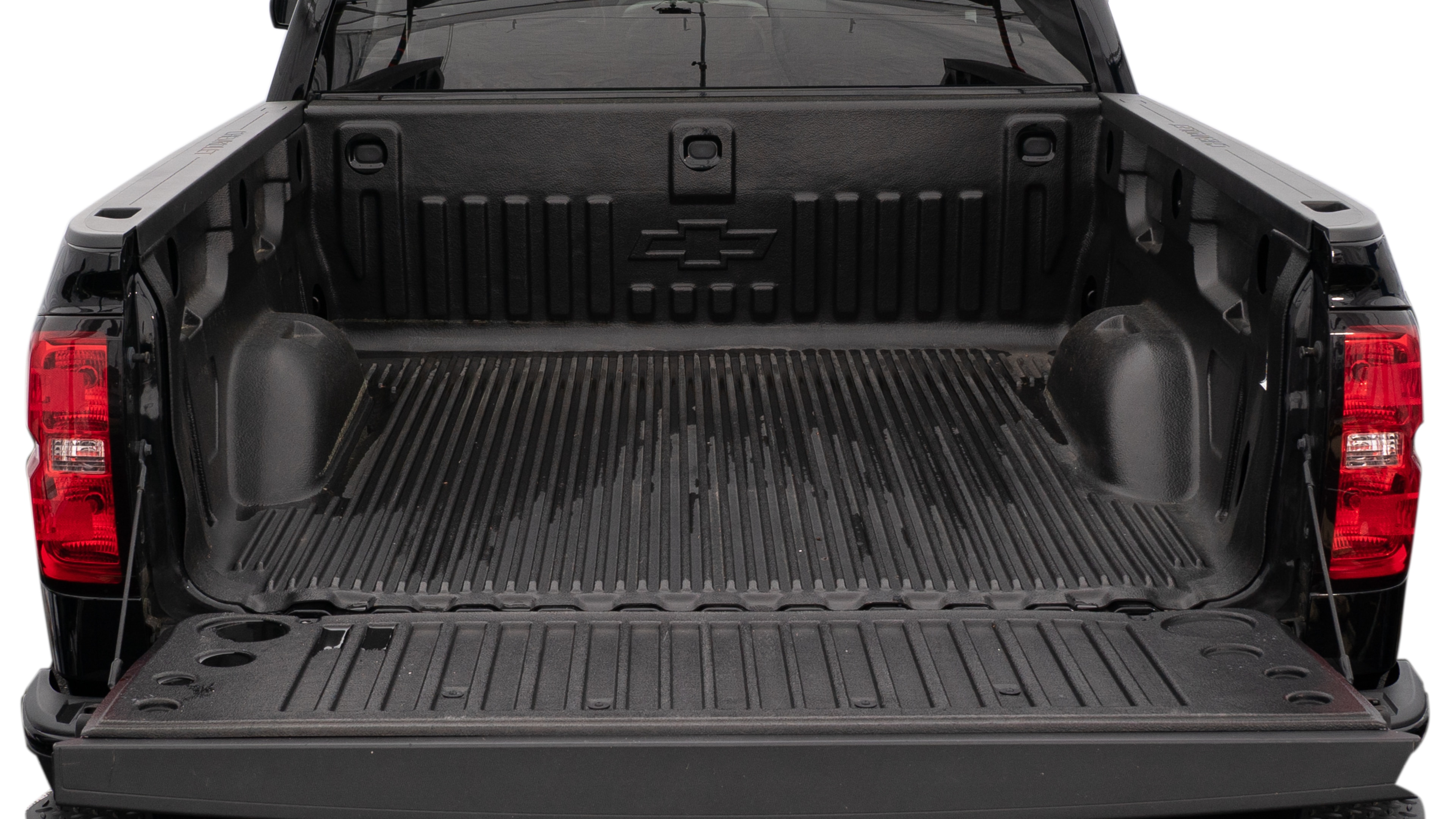 The trunk area is open giving a full view of the trunk area. A cooler, two camping chairs, a tailgate tent and a kayak are placed inside.