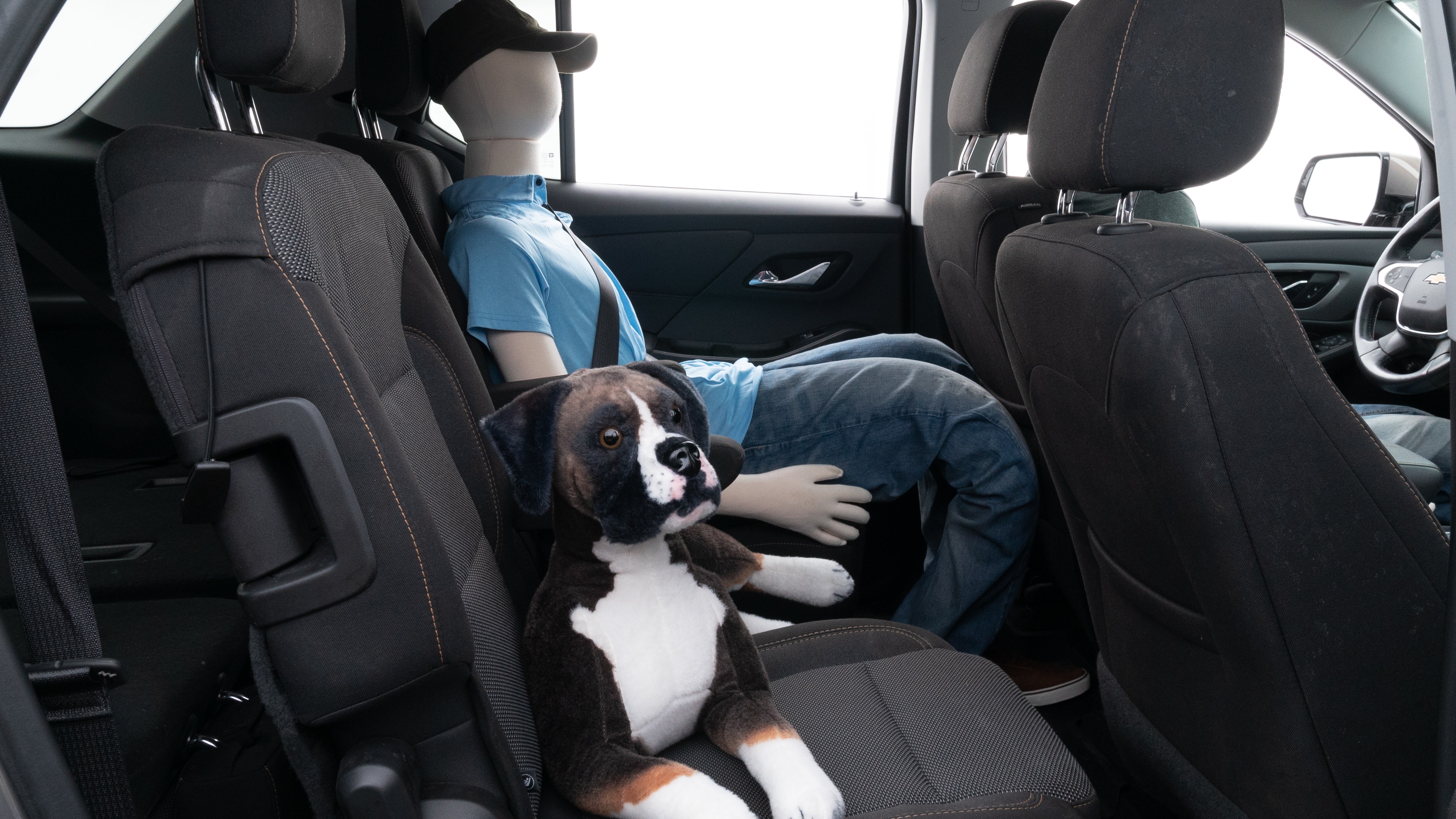 A series of second-row backseat photos is shown including one seating a baby seat and one seating a 6'1" mannequin.