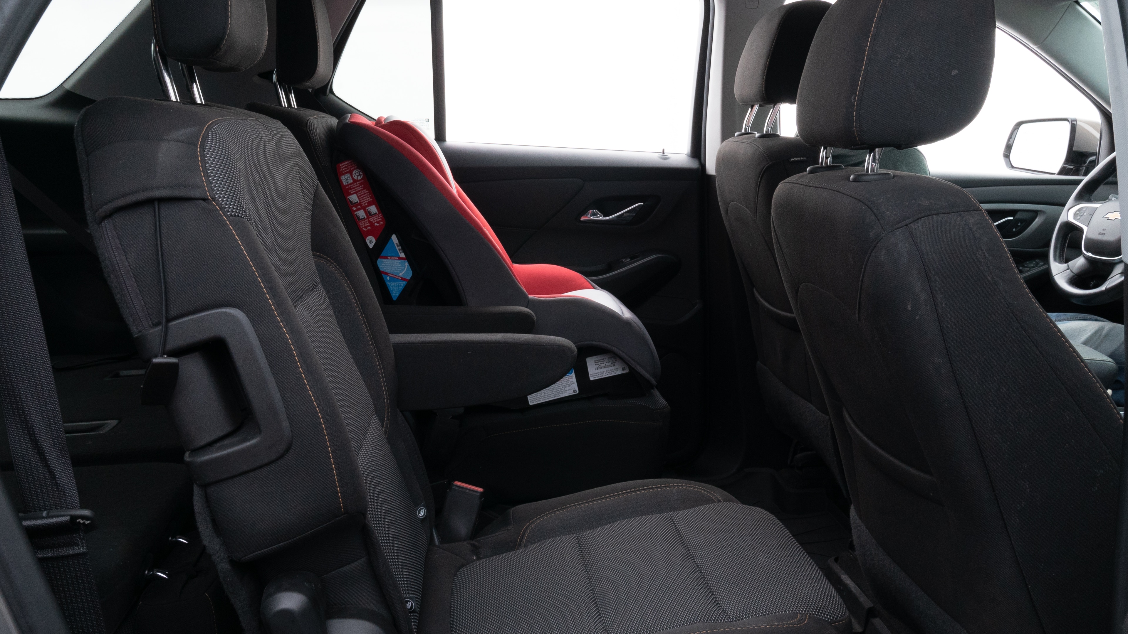A series of second-row backseat photos is shown including one seating a baby seat and one seating a 6'1" mannequin.