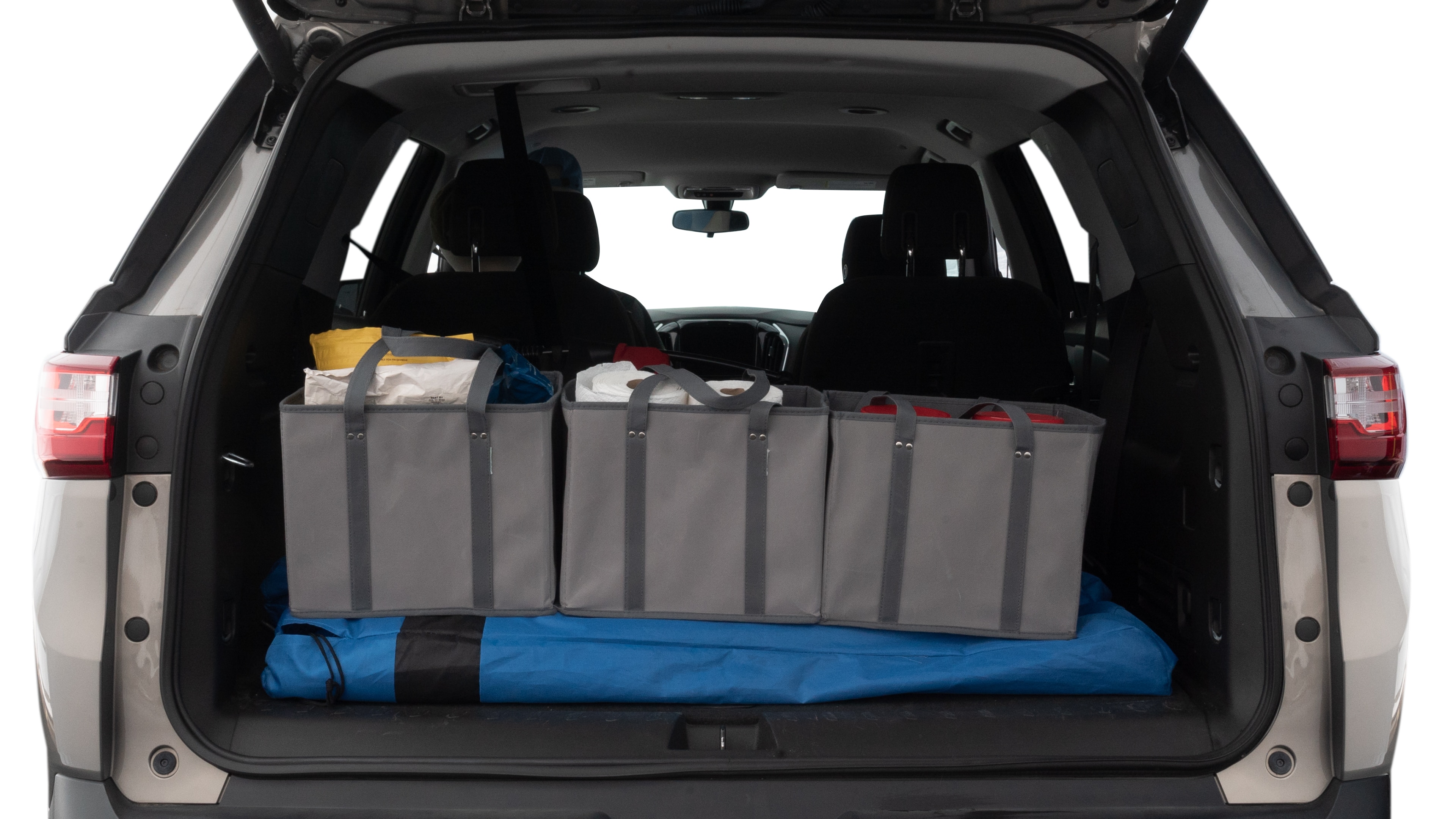 The trunk lid is open showing full view of the trunk. A baby stroller, three grocery carriers, two camping chairs in the carrying bag, and a set of golf clubs are placed inside.