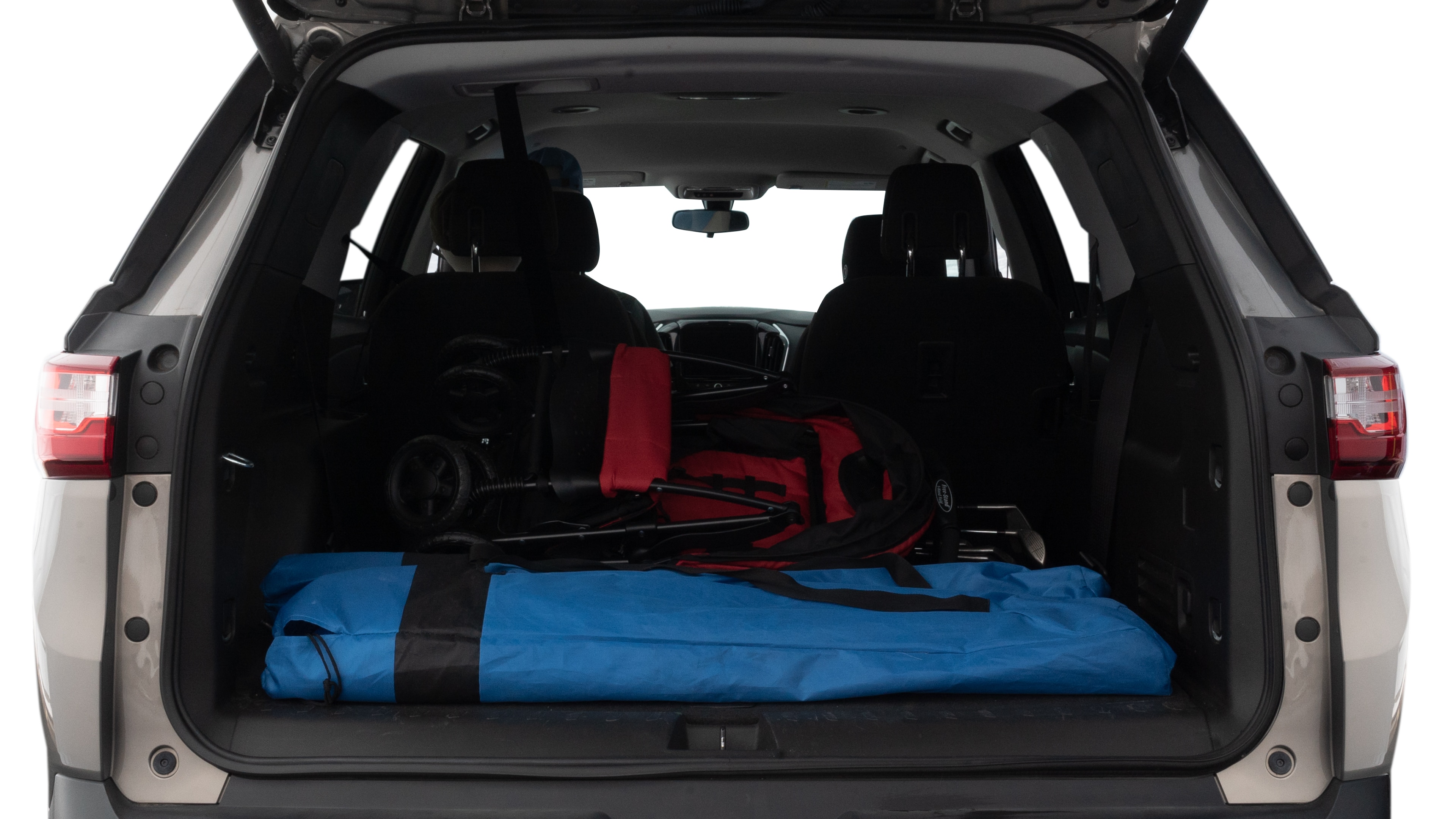 The trunk lid is open showing full view of the trunk. A baby stroller, three grocery carriers, two camping chairs in the carrying bag, and a set of golf clubs are placed inside.