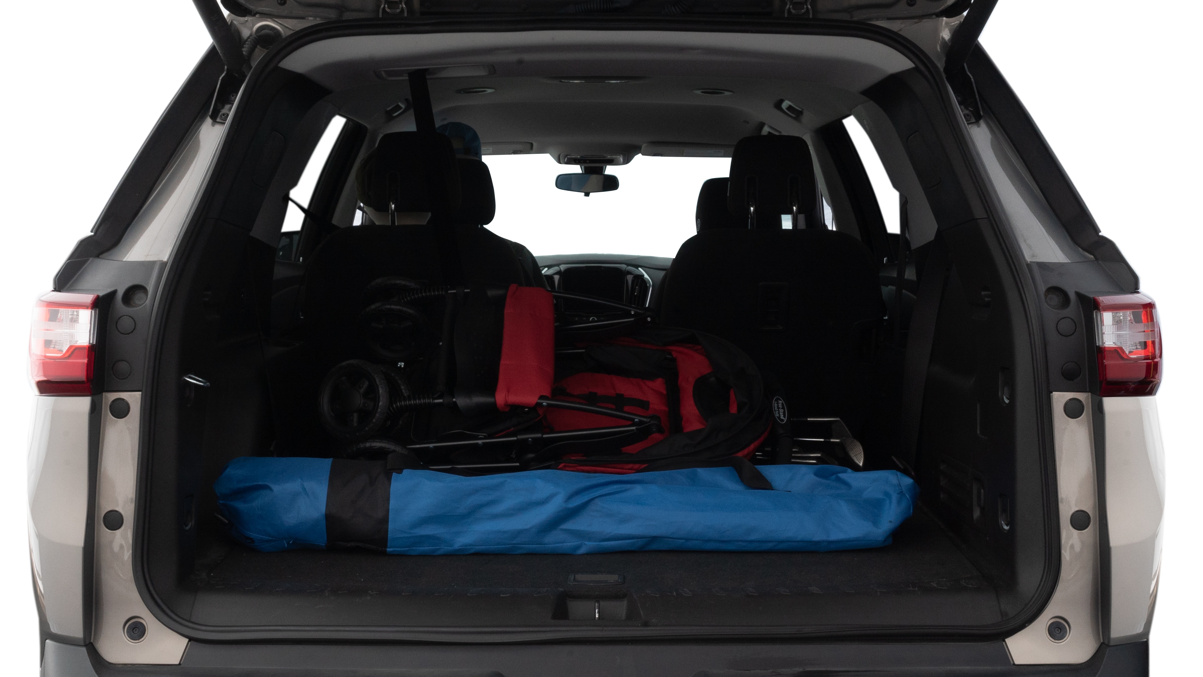The trunk lid is open showing full view of the trunk. A baby stroller, three grocery carriers, two camping chairs in the carrying bag, and a set of golf clubs are placed inside.