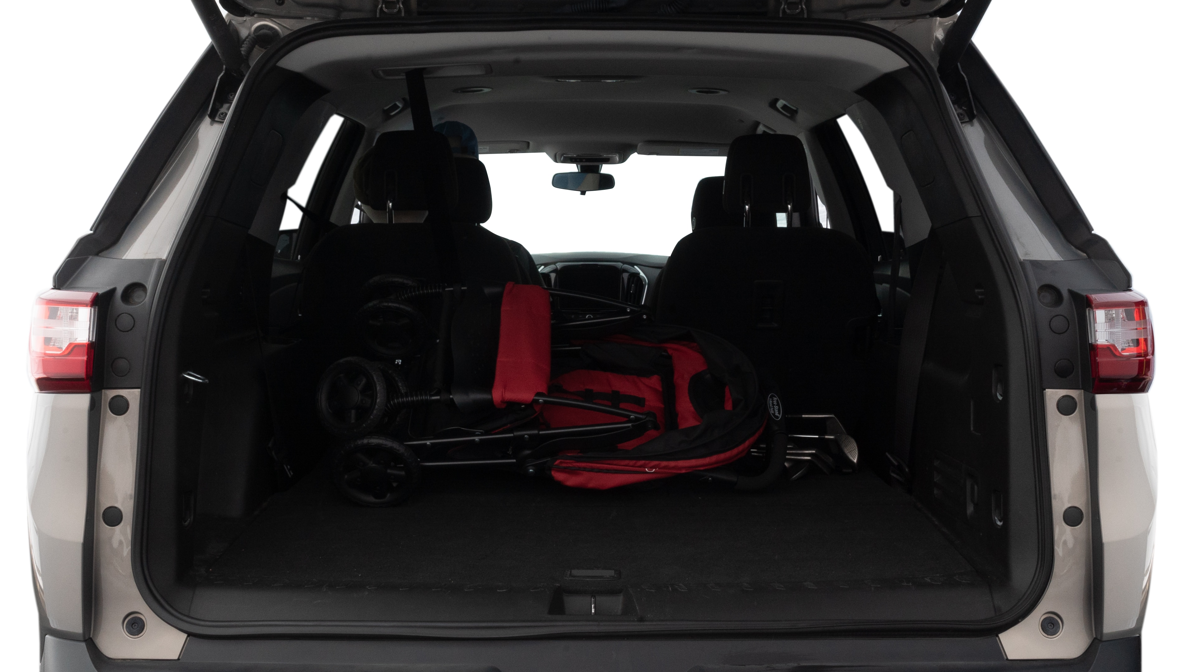 The trunk lid is open showing full view of the trunk. A baby stroller, three grocery carriers, two camping chairs in the carrying bag, and a set of golf clubs are placed inside.