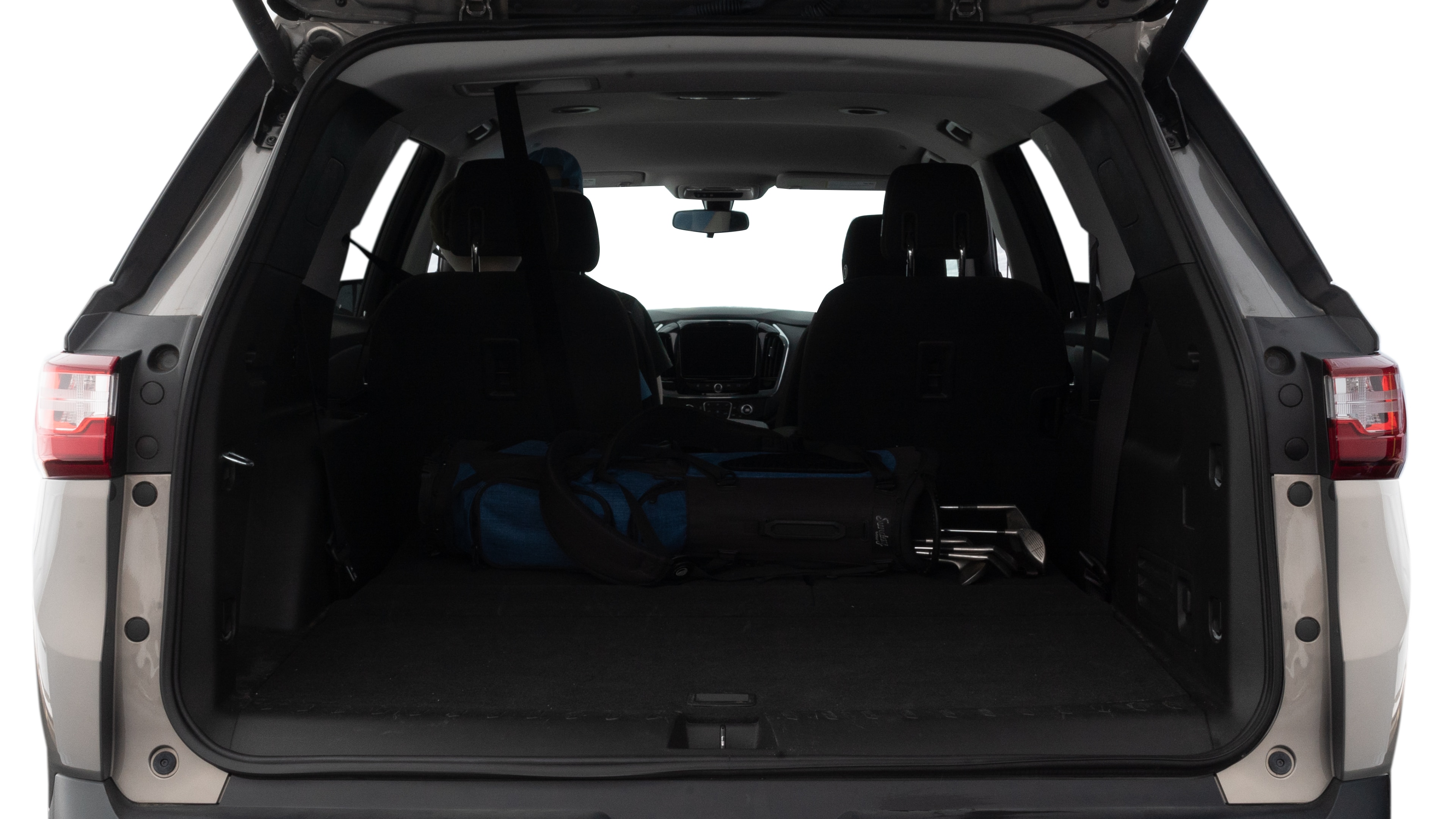 The trunk lid is open showing full view of the trunk. A baby stroller, three grocery carriers, two camping chairs in the carrying bag, and a set of golf clubs are placed inside.
