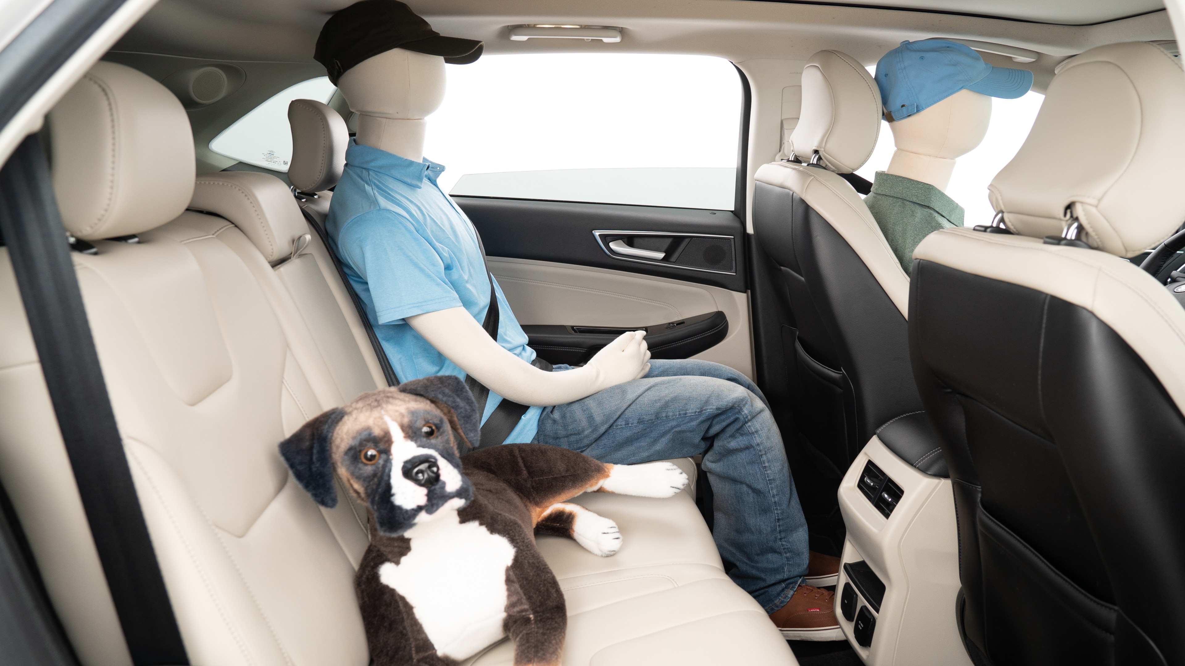 A series of second-row backseat photos is shown including one seating a baby seat, a dog and one seating a 6'1" mannequin.