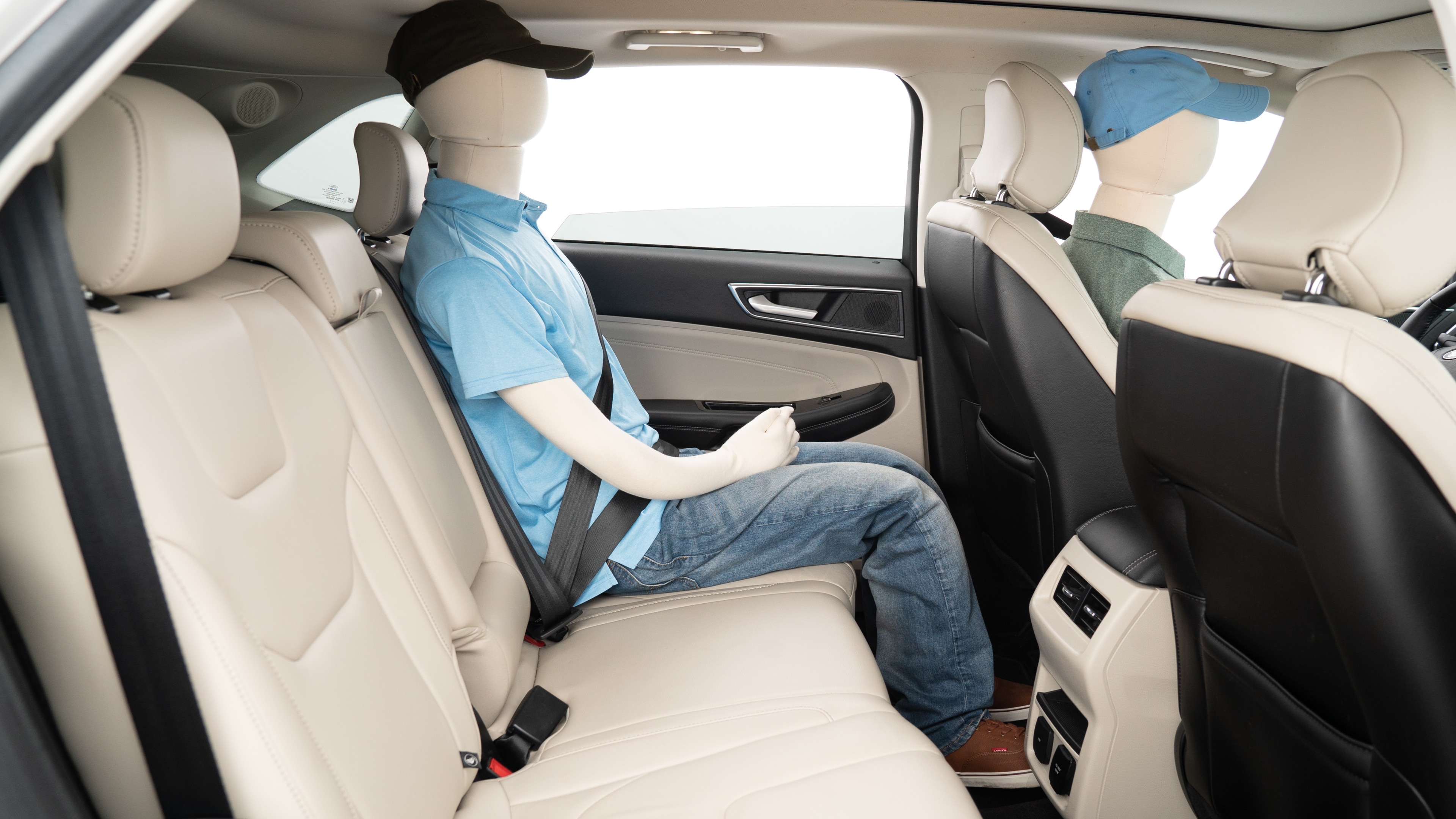 A series of second-row backseat photos is shown including one seating a baby seat, a dog and one seating a 6'1" mannequin.