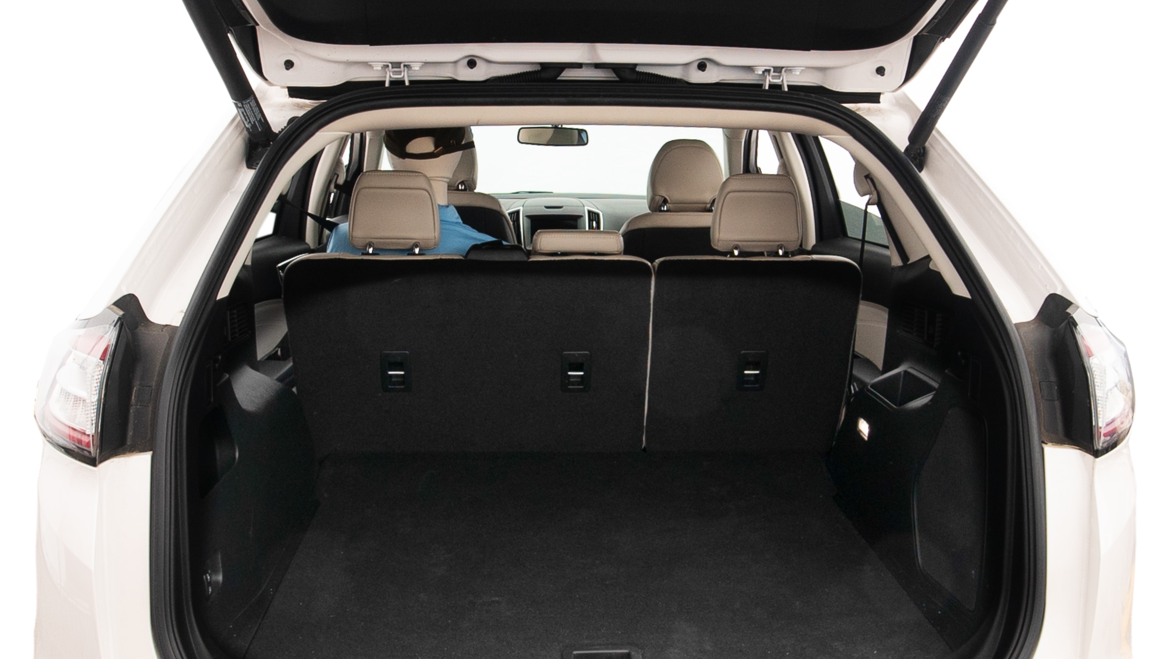 The trunk lid is open showing full view of the trunk. A baby stroller, three grocery carriers, two camping chairs in the carrying bag, and a set of golf clubs are placed inside.