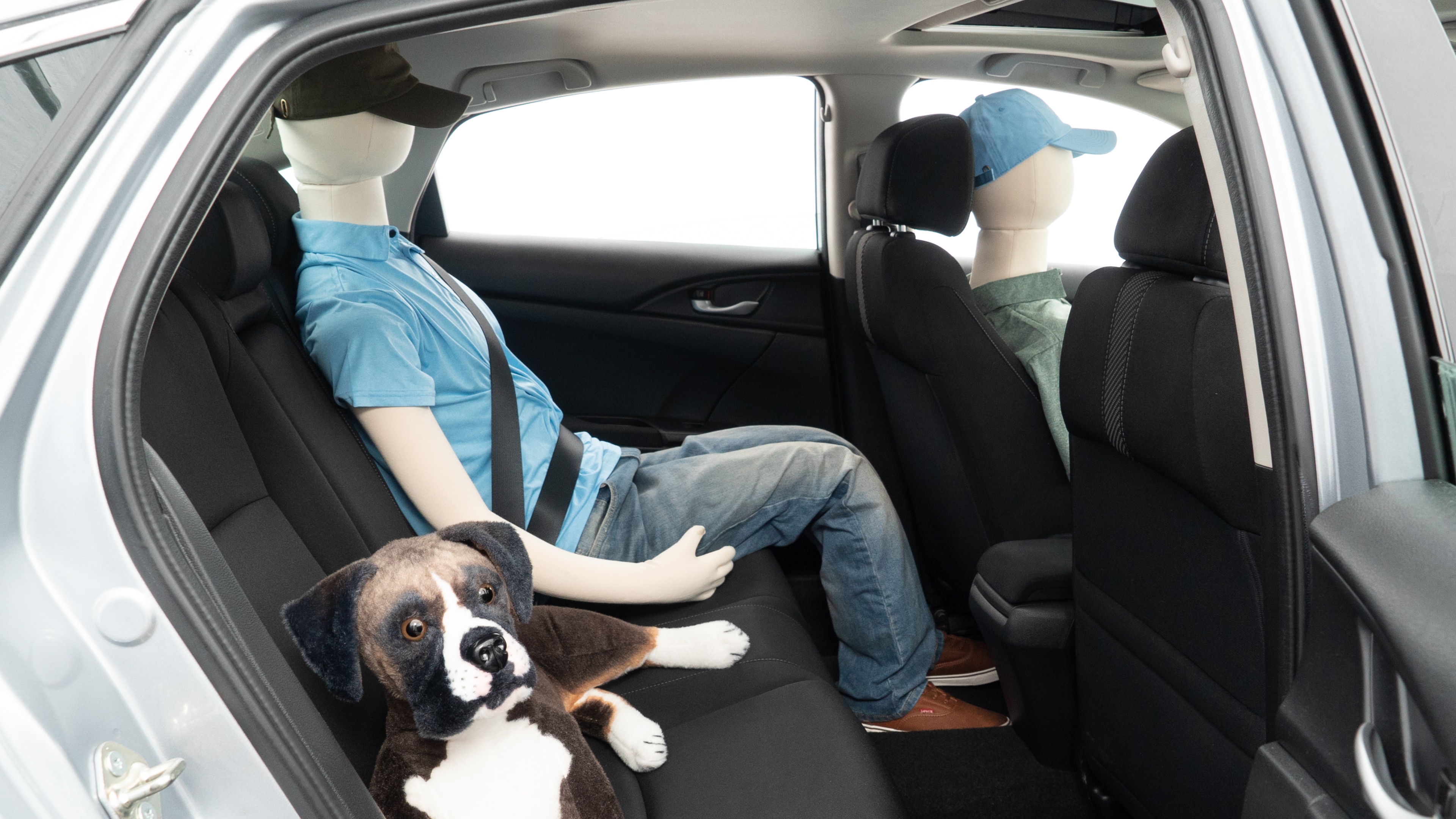 A series of second-row backseat photos is shown including one seating a baby seat and one seating a 6'1" mannequin.