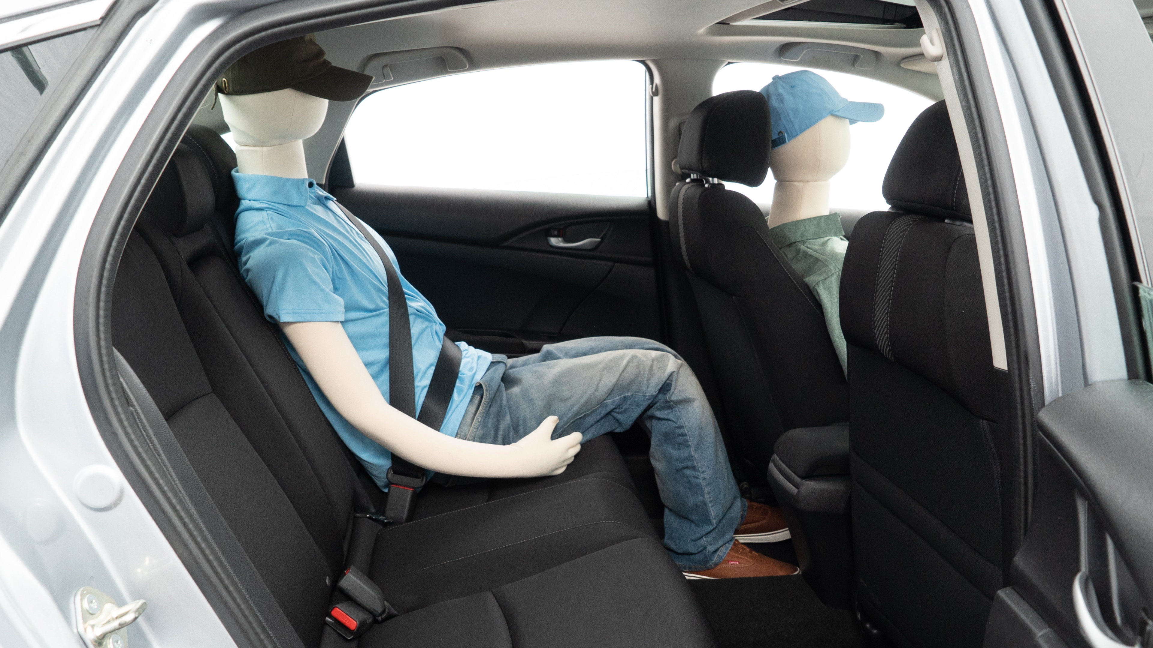 A series of second-row backseat photos is shown including one seating a baby seat and one seating a 6'1" mannequin.