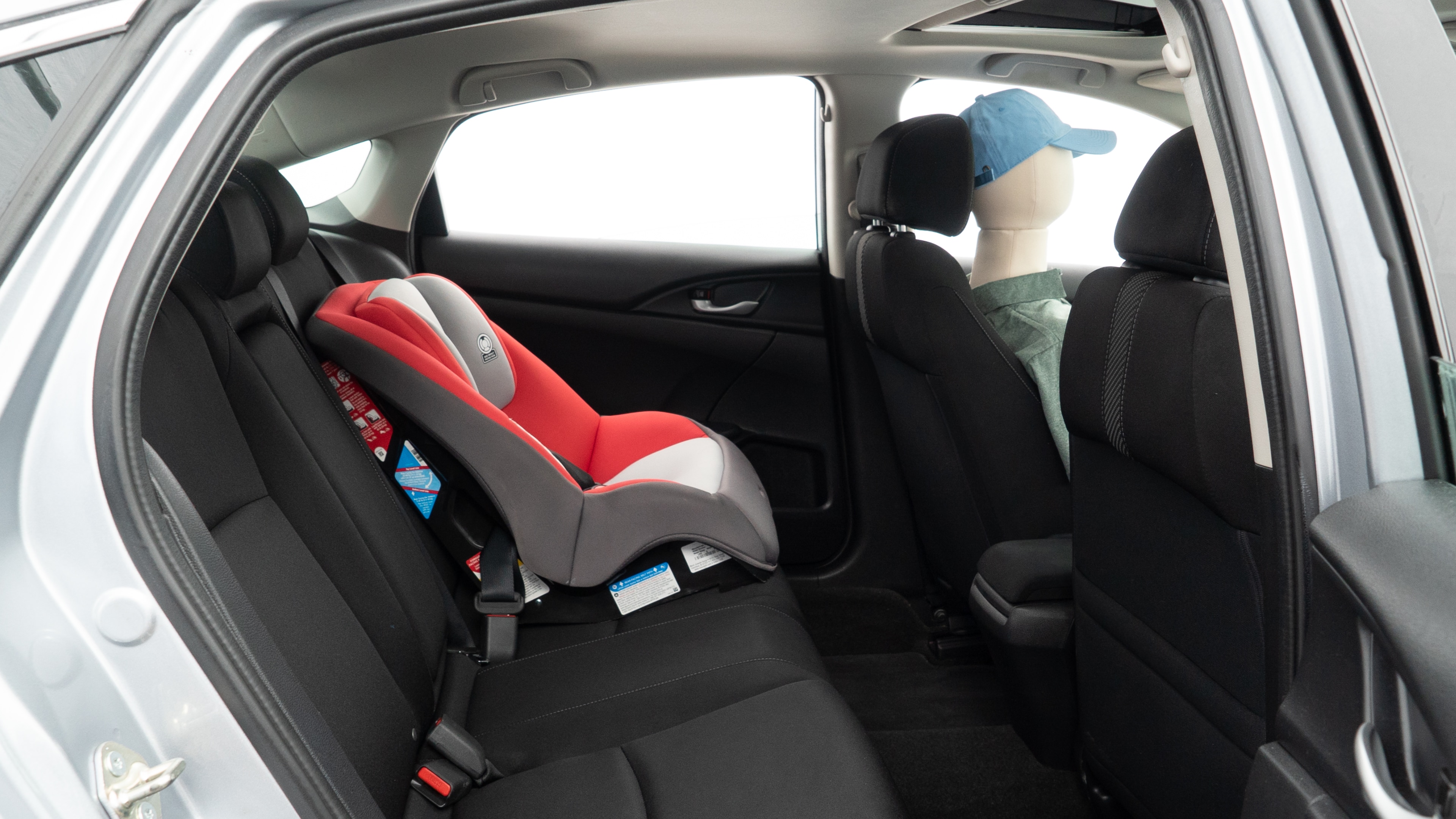 A series of second-row backseat photos is shown including one seating a baby seat and one seating a 6'1" mannequin.