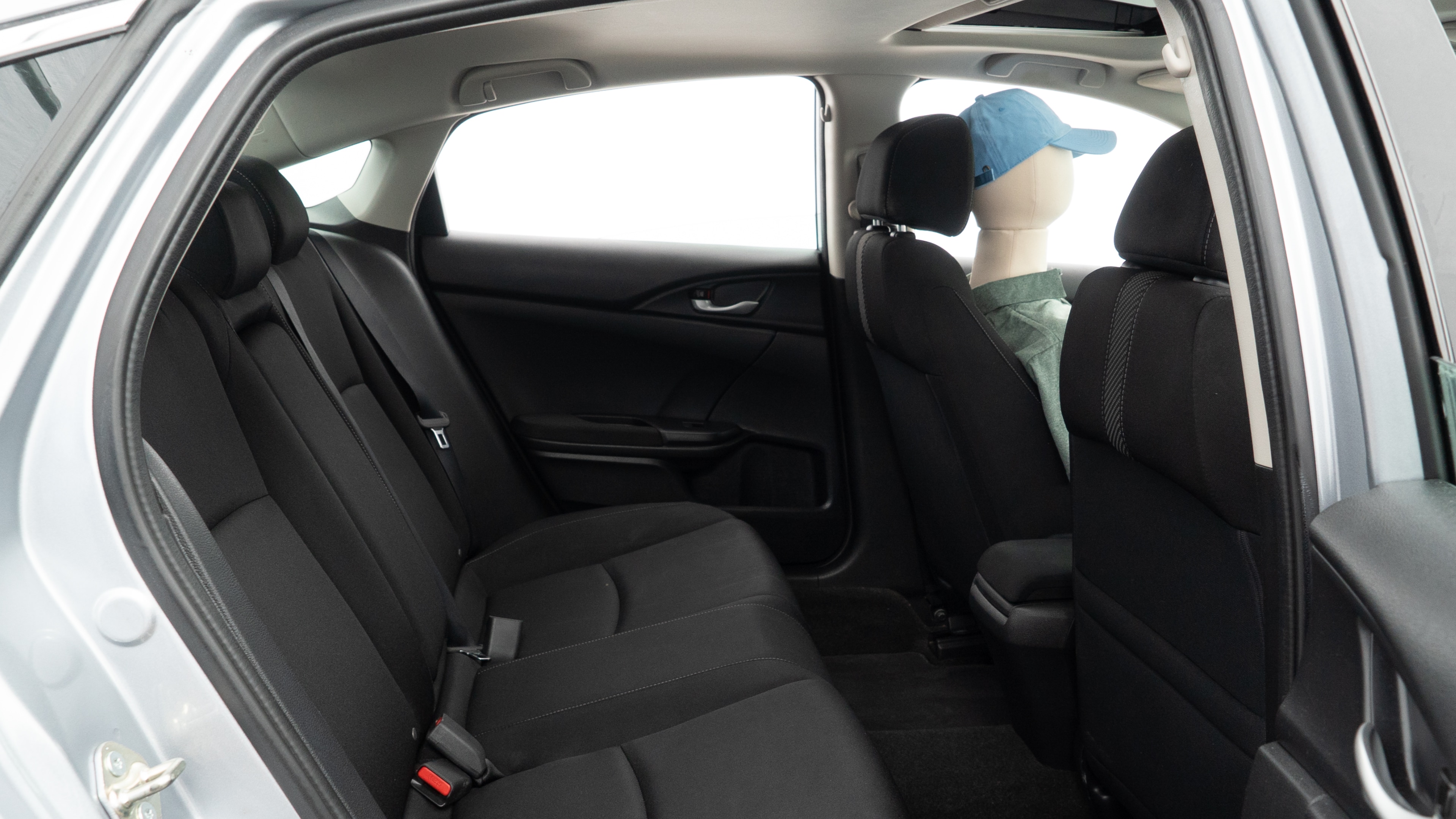 A series of second-row backseat photos is shown including one seating a baby seat and one seating a 6'1" mannequin.