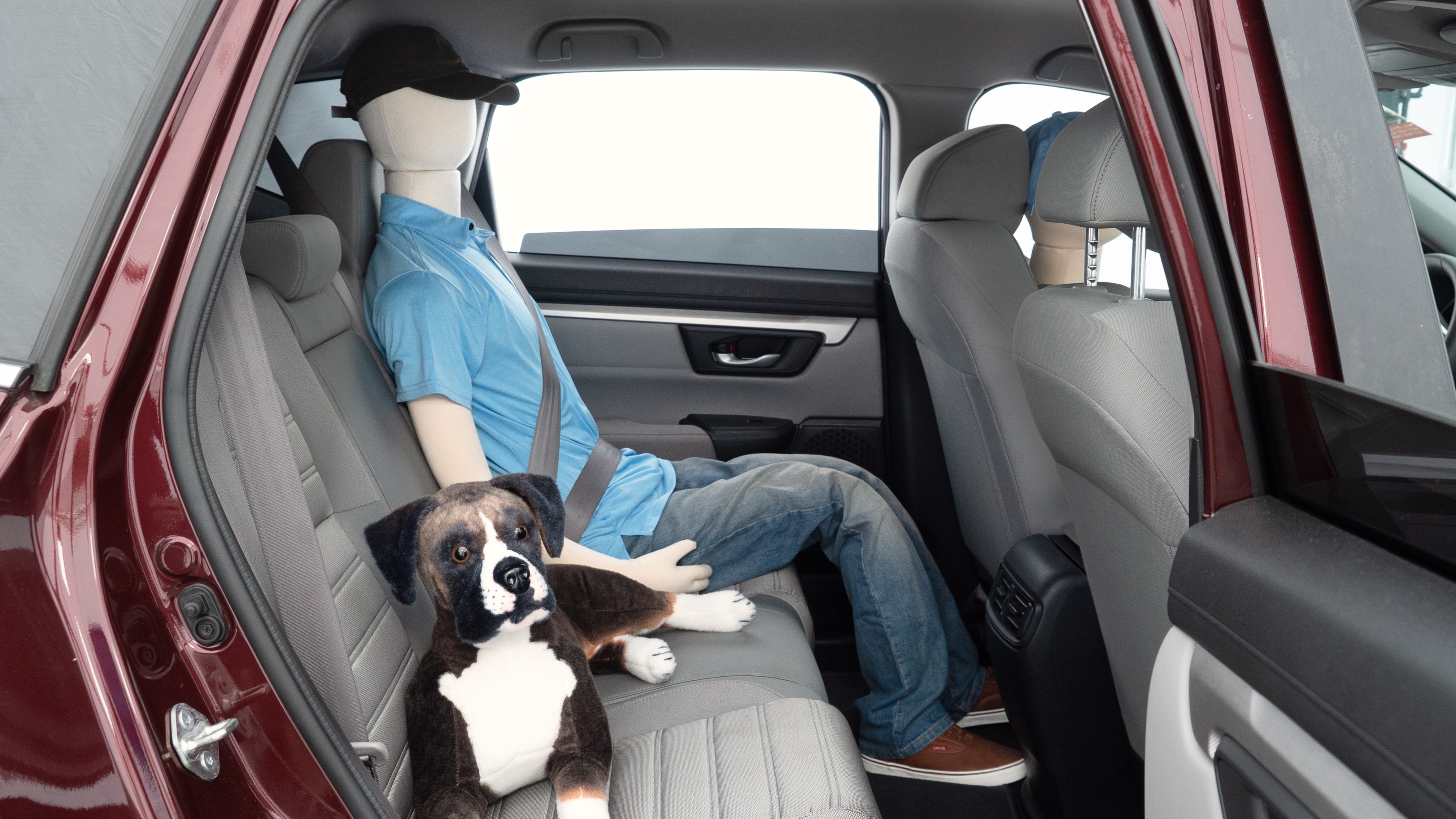 A series of second-row backseat photos is shown including one seating a baby seat and one seating a 6'1" mannequin.