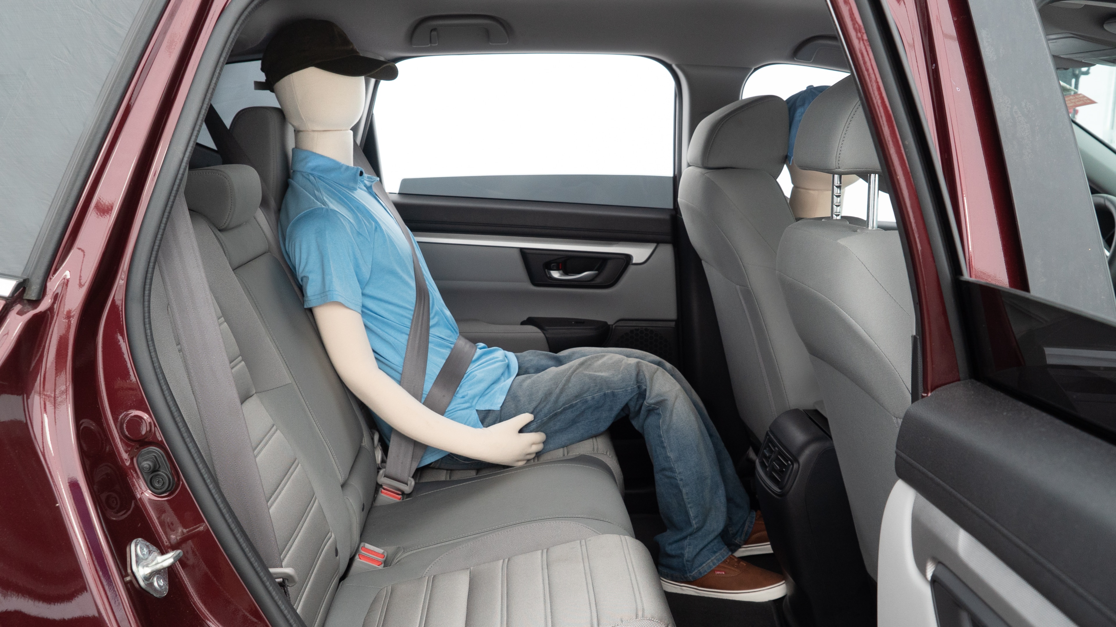 A series of second-row backseat photos is shown including one seating a baby seat and one seating a 6'1" mannequin.